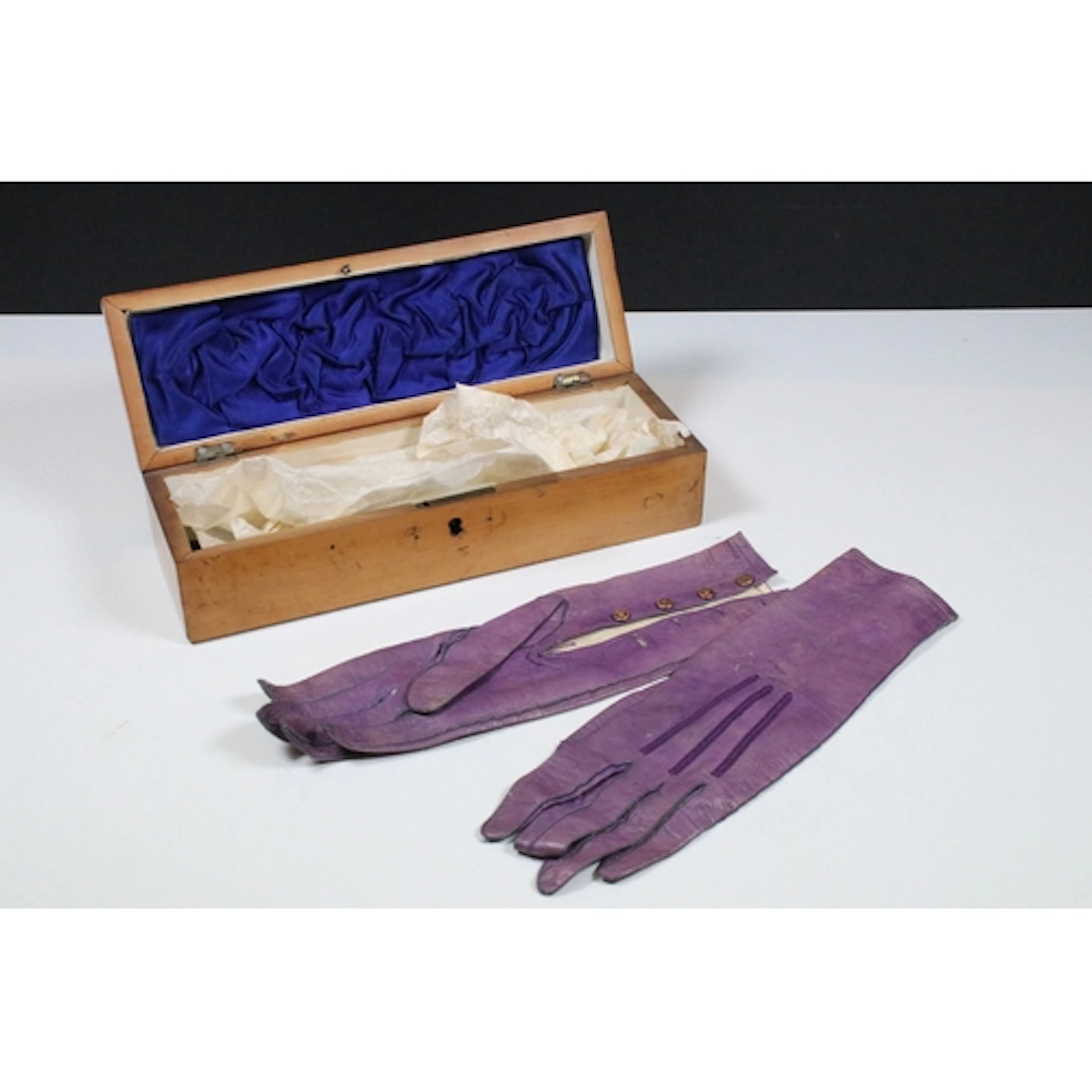Pair of early 20th century purple leather gloves, having gol...