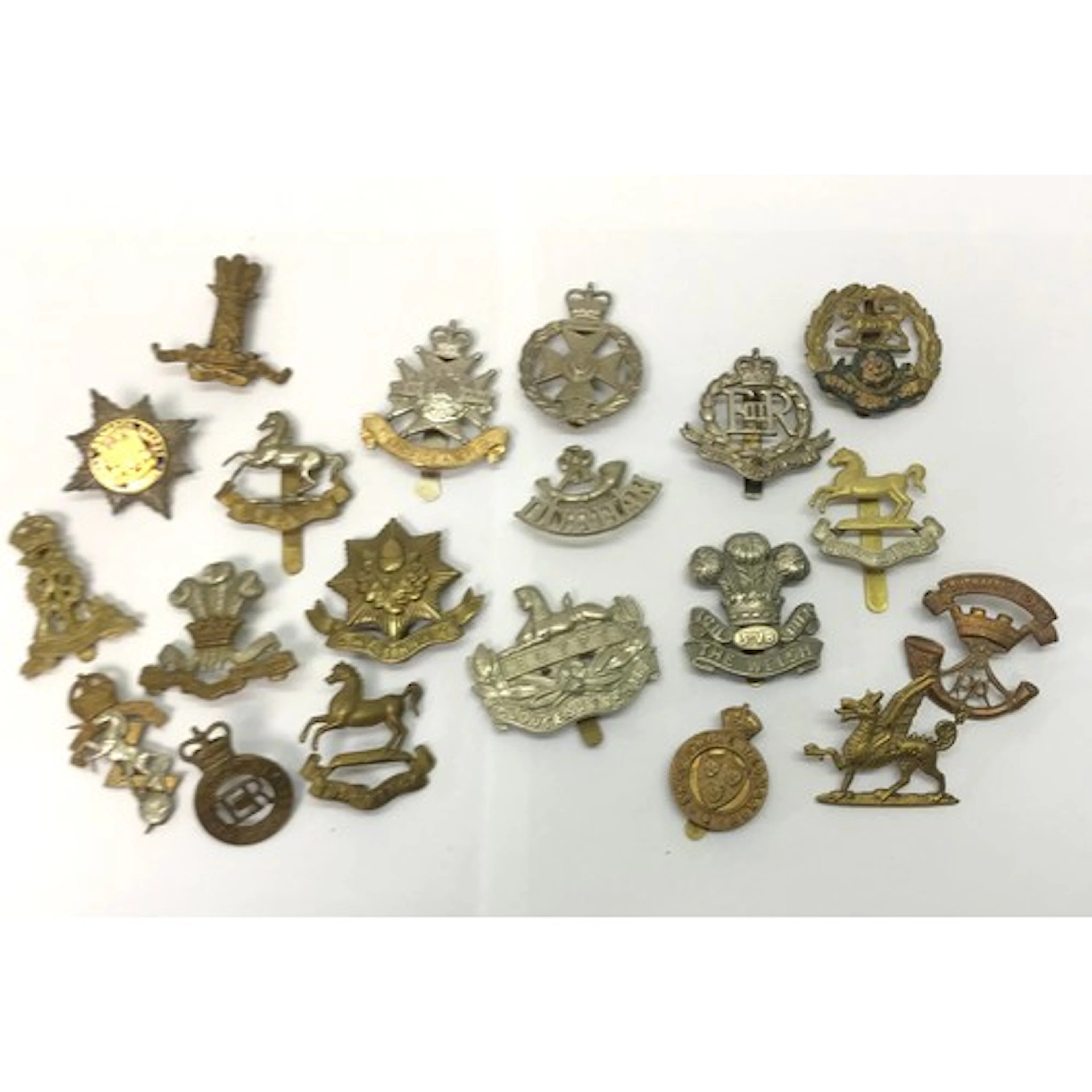 A group of British Army badges and shoulder titles, most WW2...