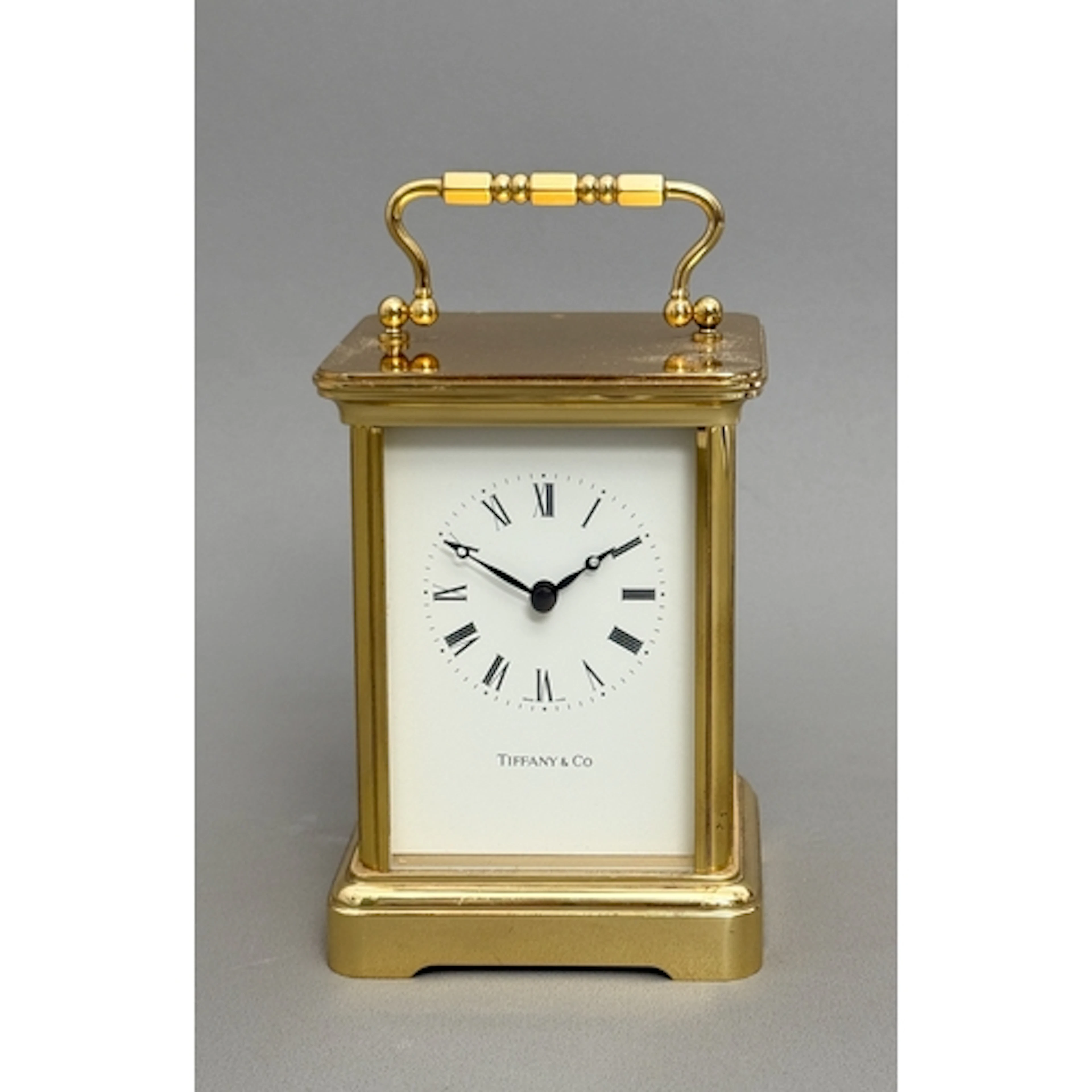 A Tiffany & Co brass cased carriage clock - with quartz move...