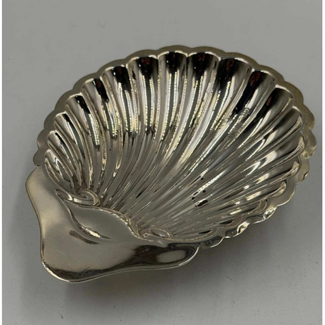 A silver butter or bonbon dish on three ball feet with an ap...