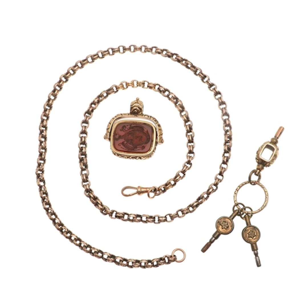 A 9CT GOLD WATCH CHAIN AND SWIVEL FOB. the watch chain forme...