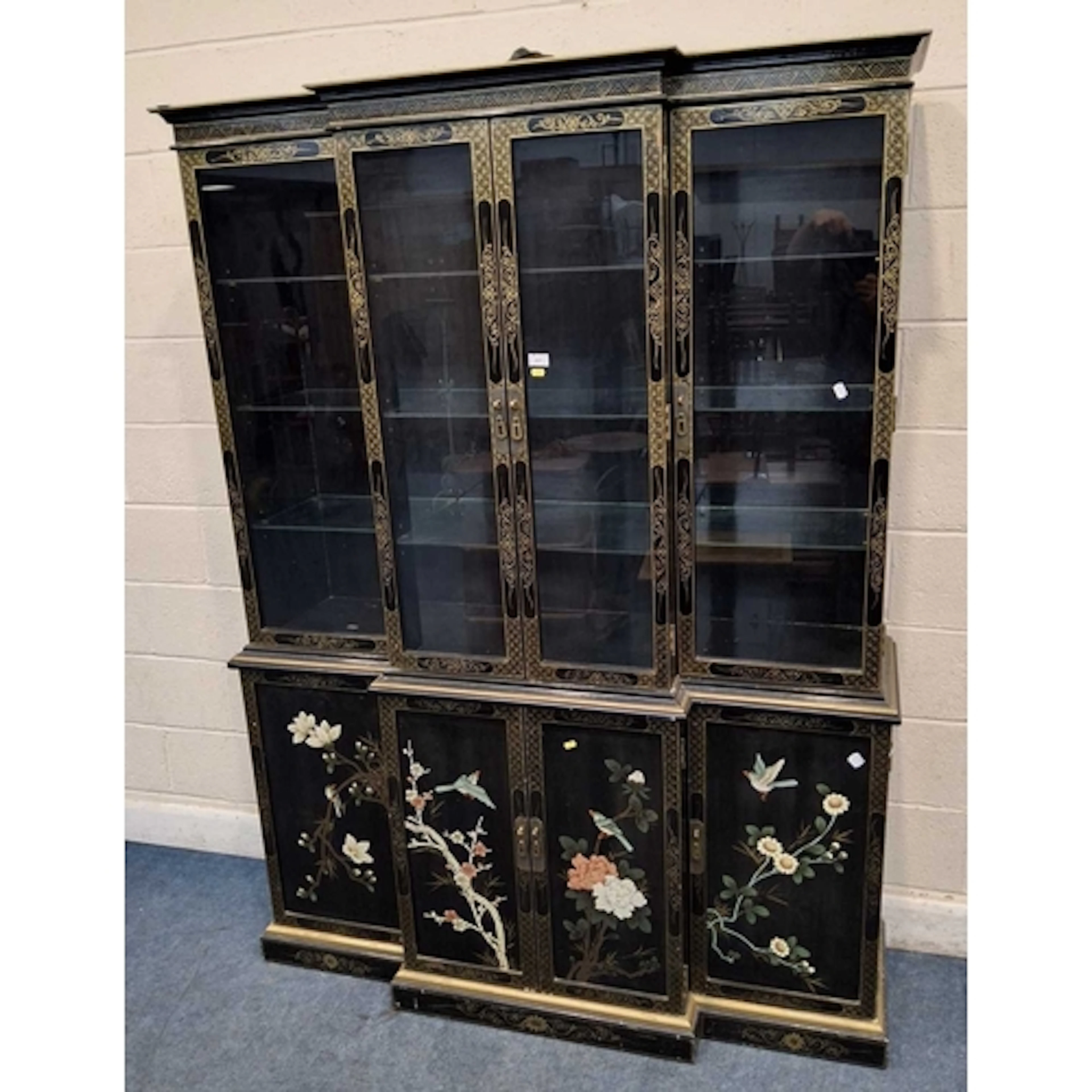 AN EBONISED AND JAPANNED BREAKFRONT DRESSER, the four glass ...
