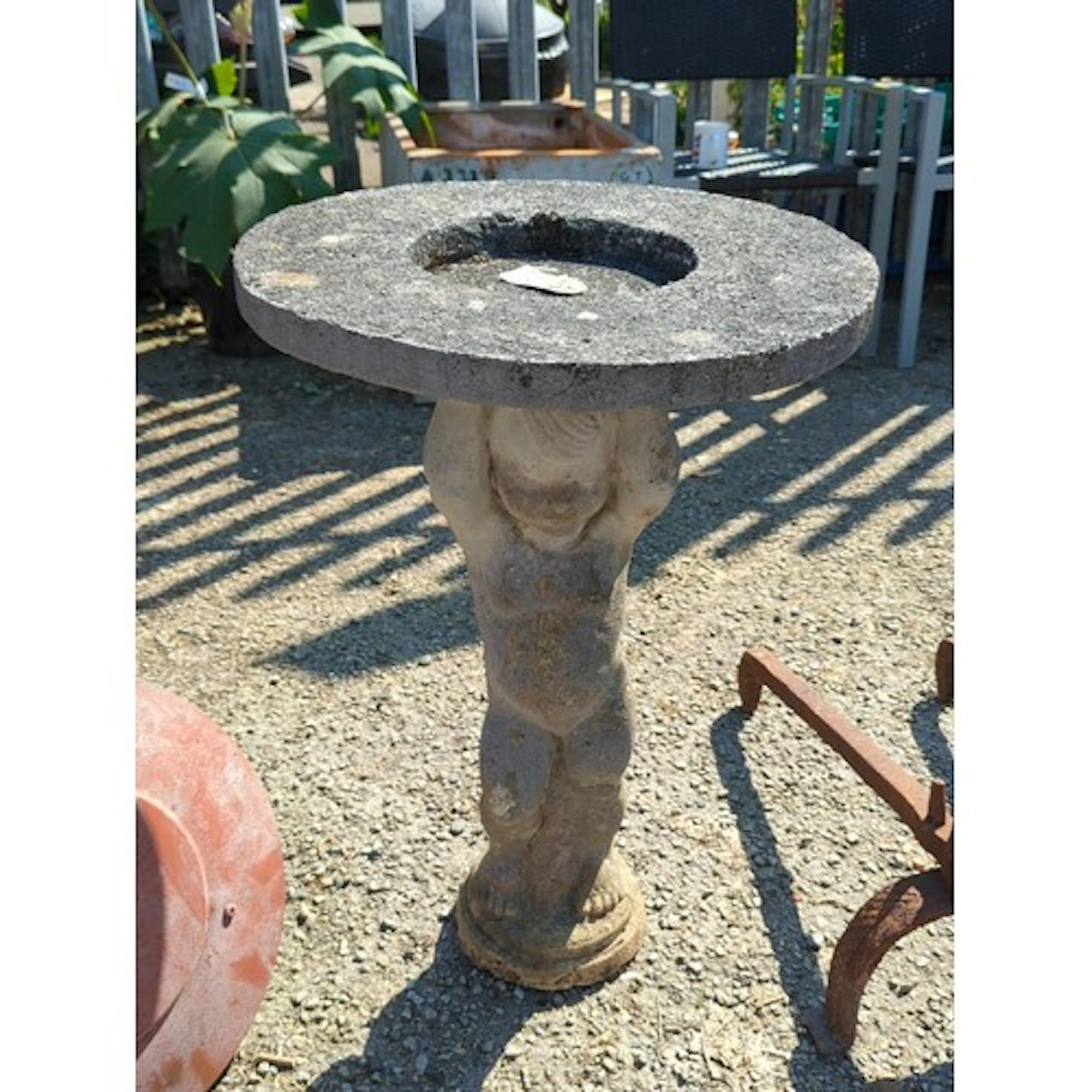 Concrete birdbath or garden pedestal, the shallow circular b...