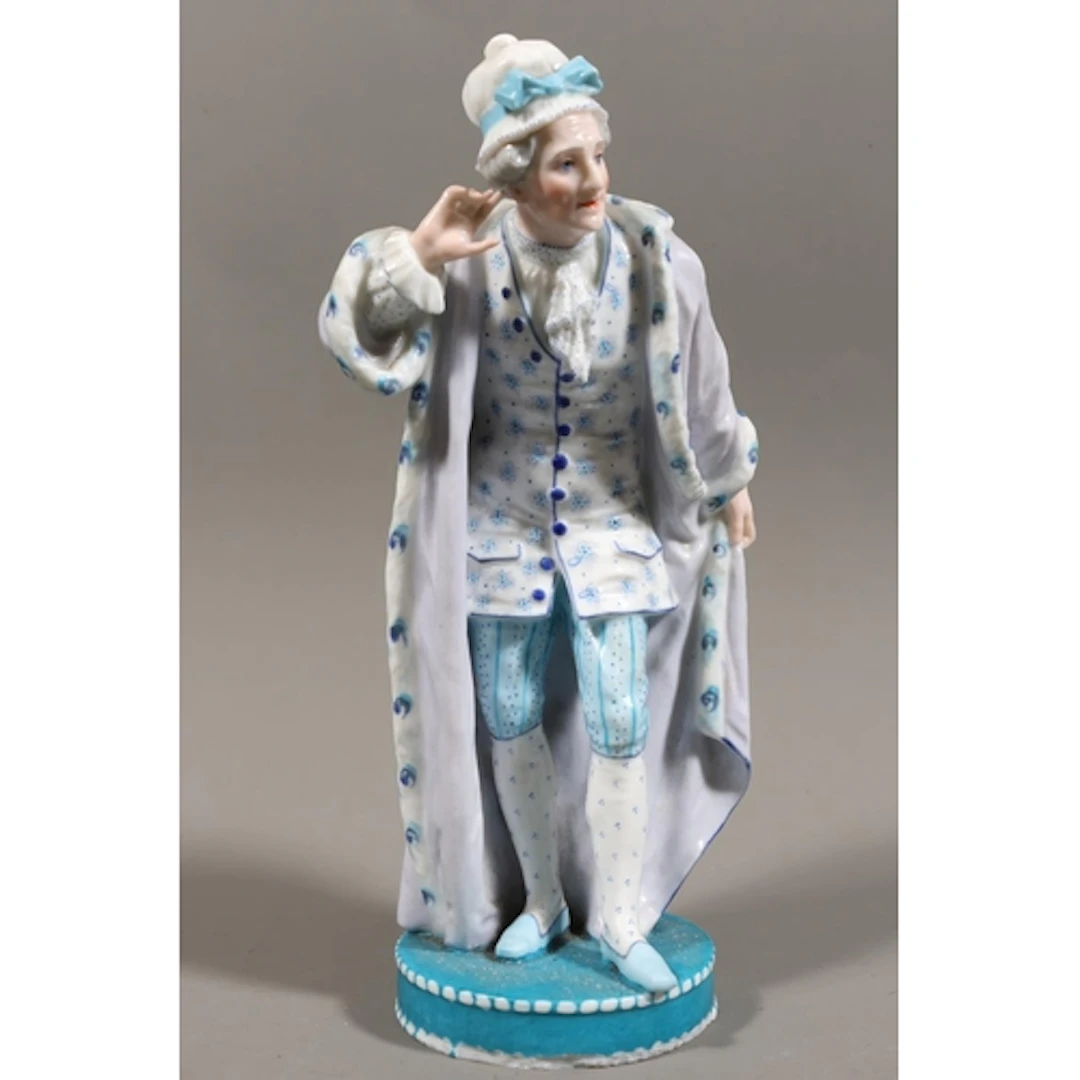 Hard paste ceramic figure modelled as an elderly lady in gow...