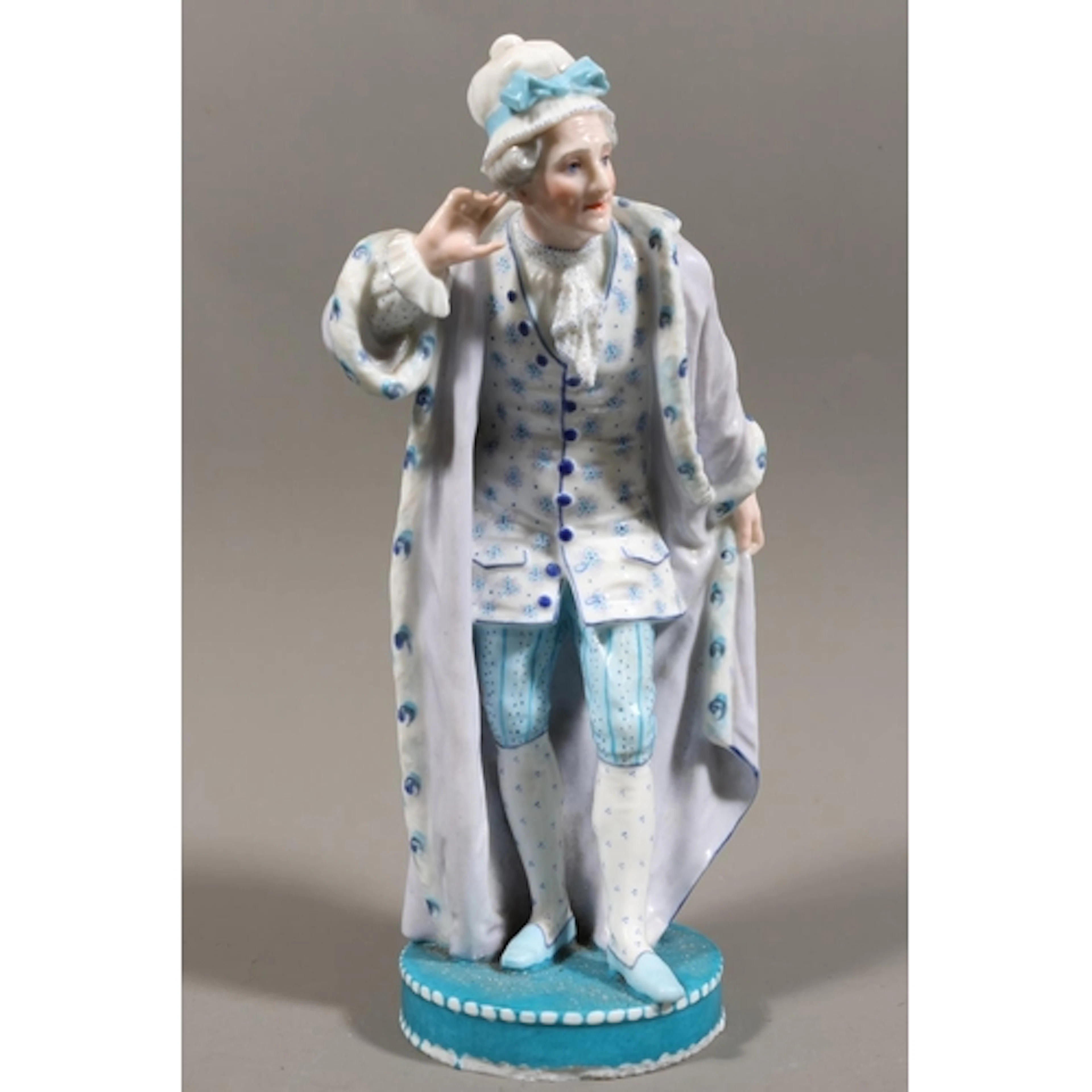Hard paste ceramic figure modelled as an elderly lady in gow...