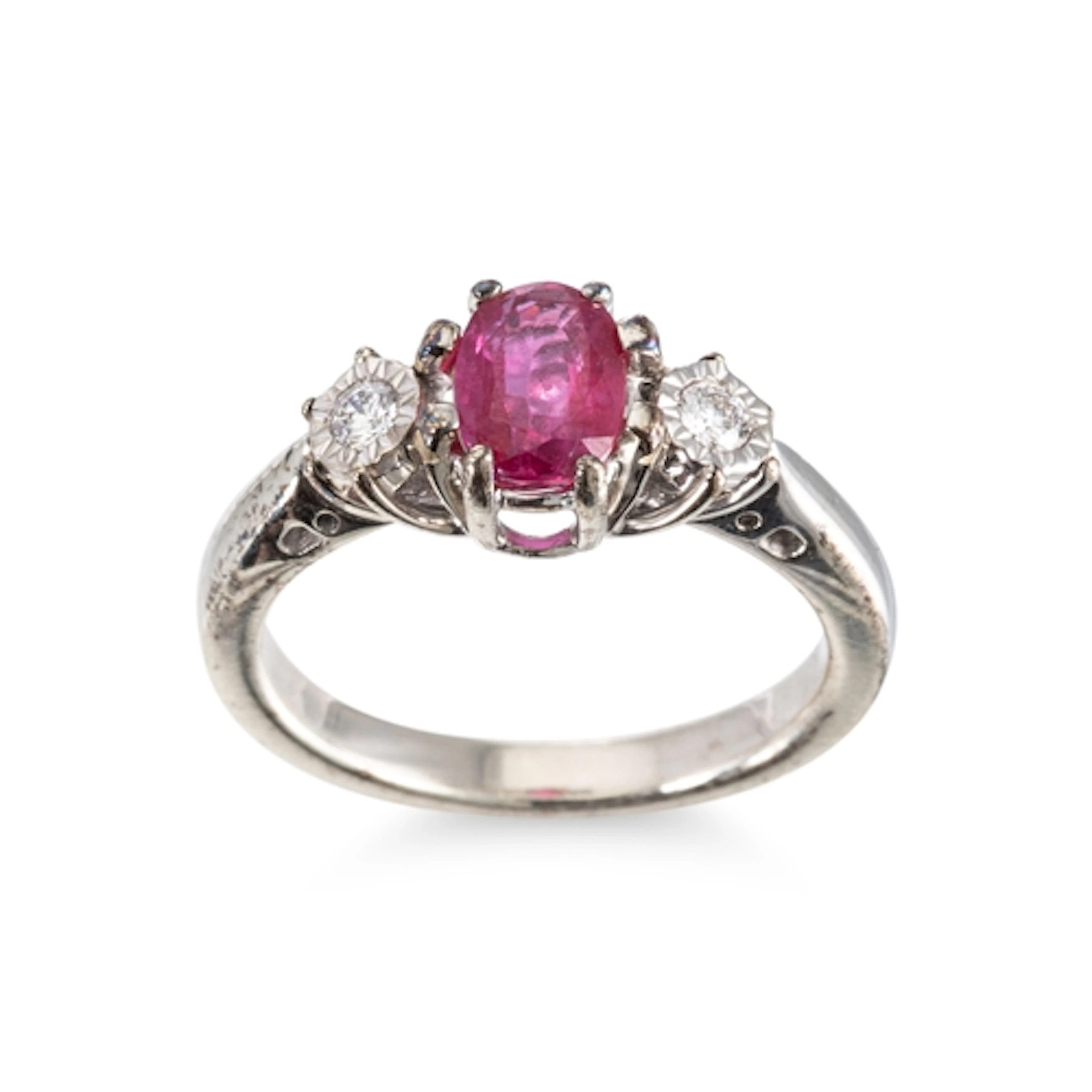 A RUBY AND DIAMOND THREE STONE RING, the central oval cut ru...