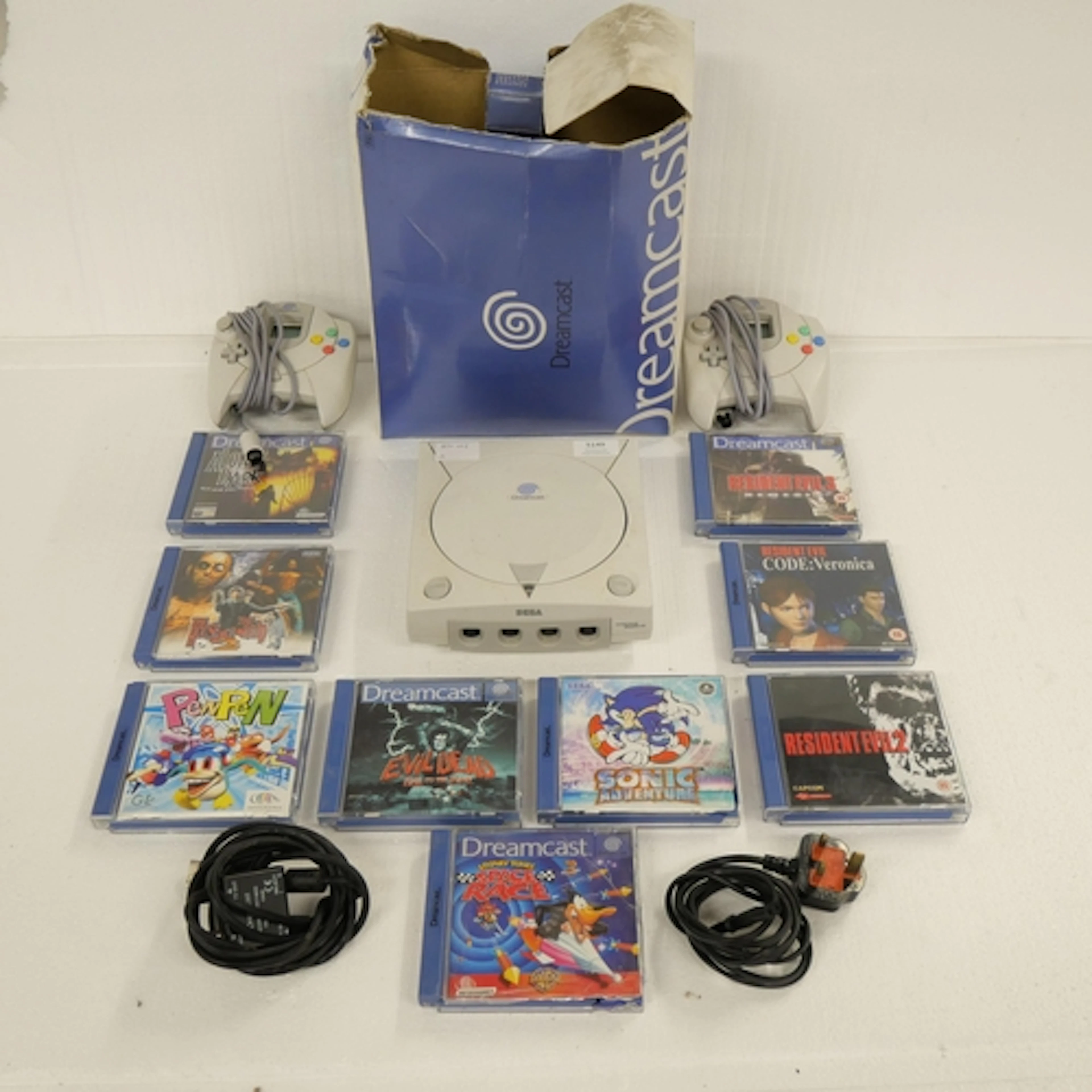 A Sega Dreamcast games console with box, instructions manual...