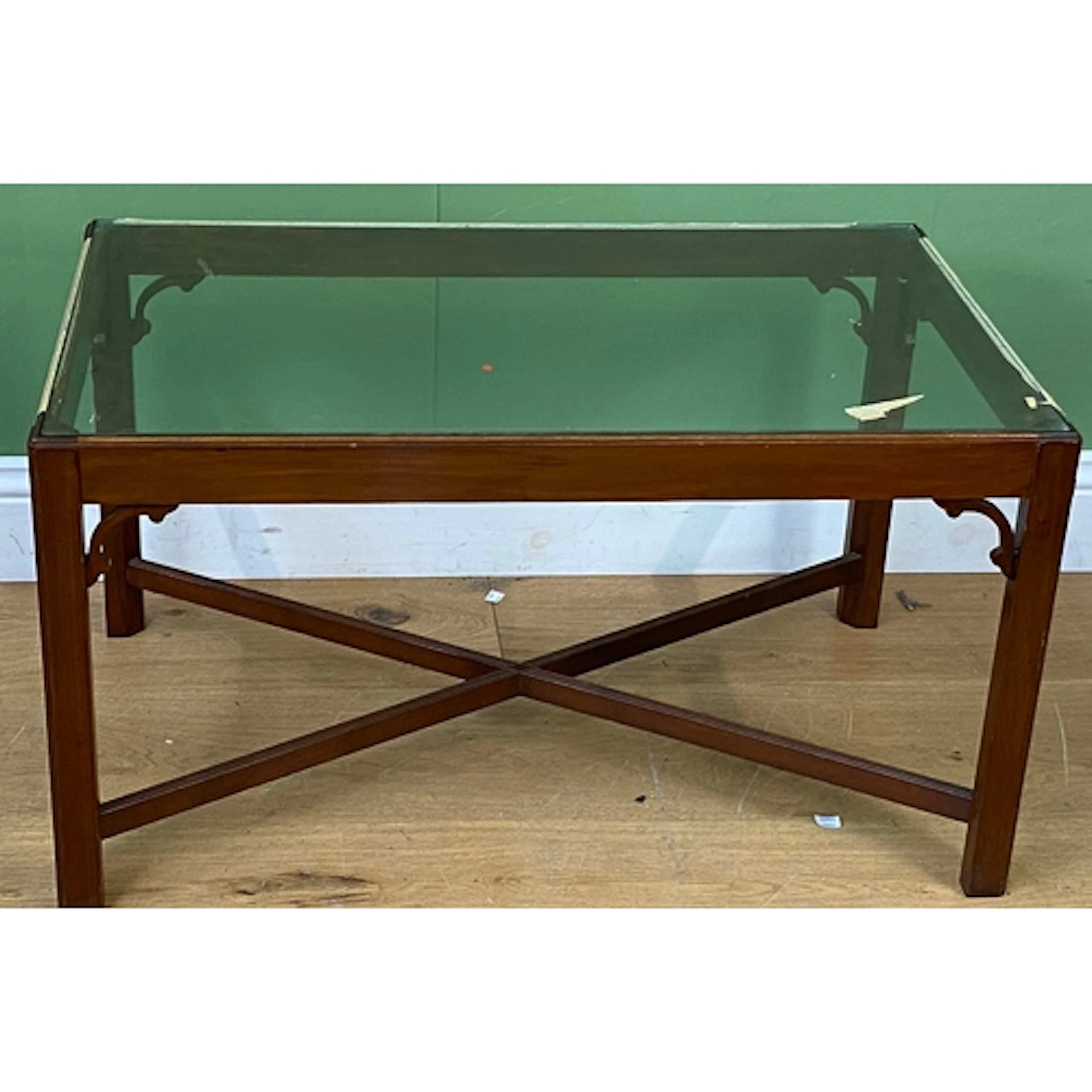 A mahogany and glass topped coffee table, modelled in Georgi...