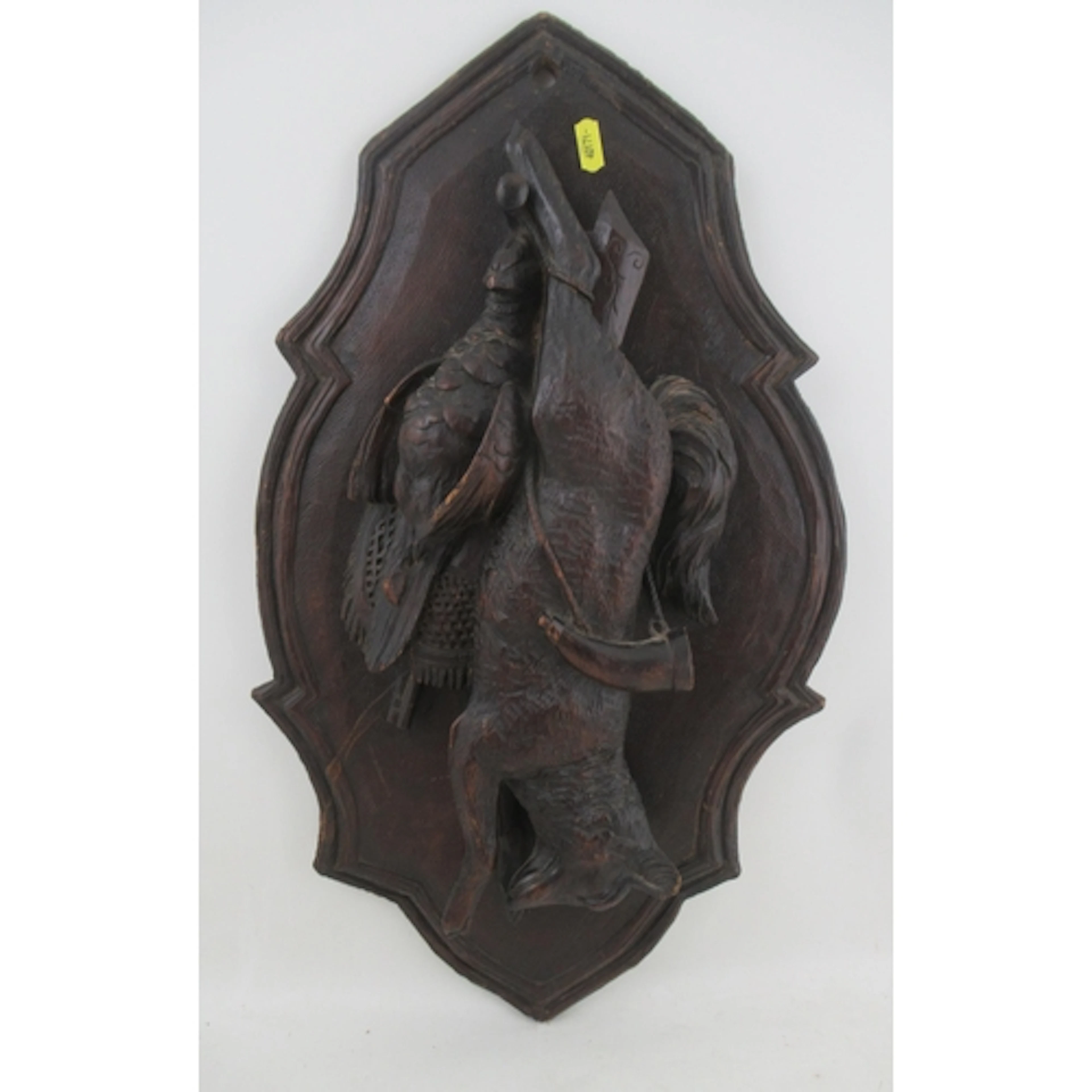 An antique Black Forest carved wooden shield, decorated with...