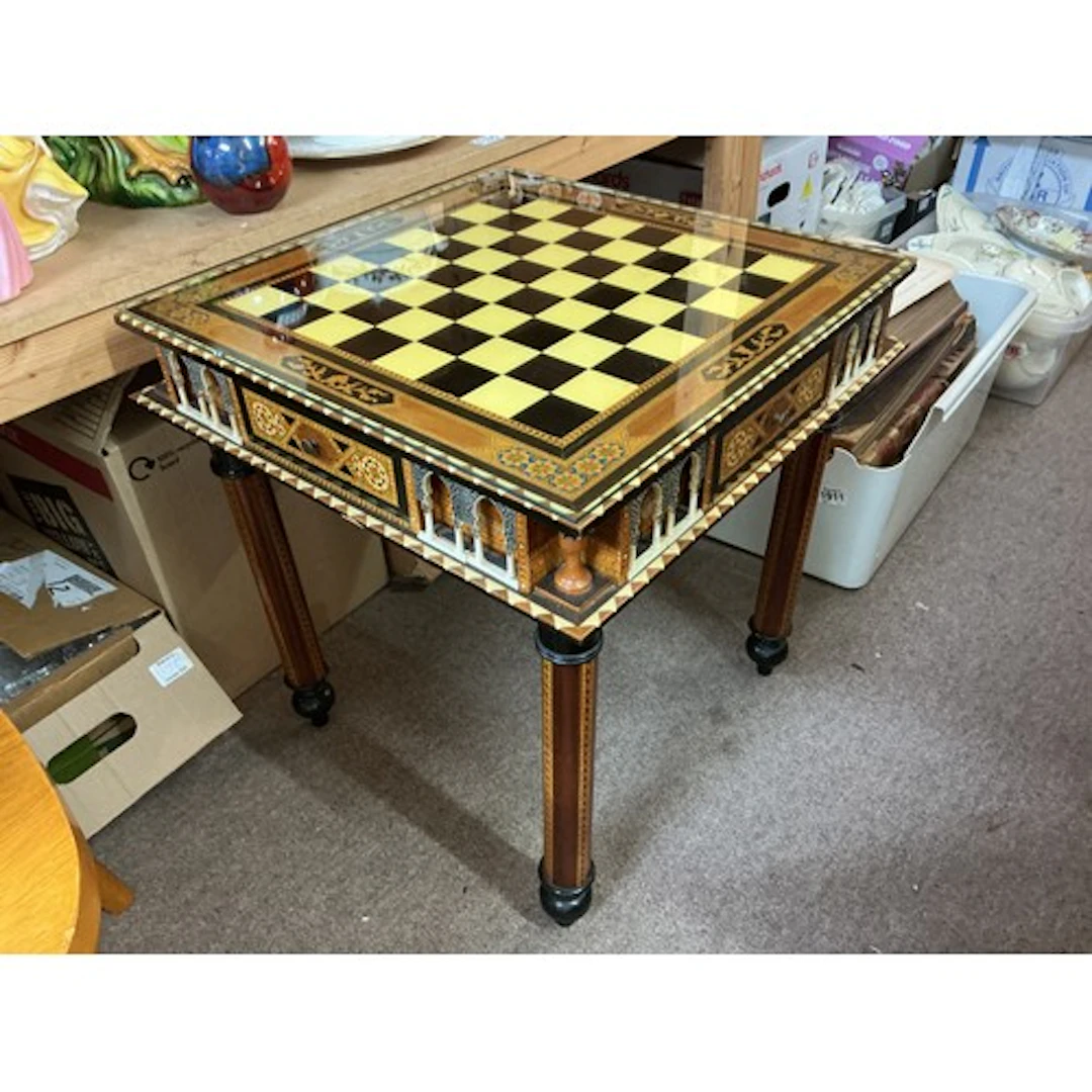 A modern chess table with chess set pieces of classical Troj...
