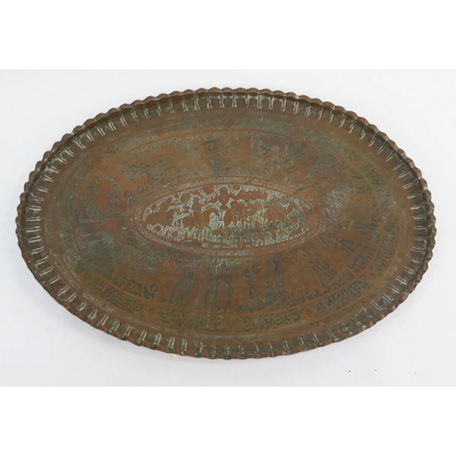 An Arabic brass tiffin table top of oval form with crimped b...