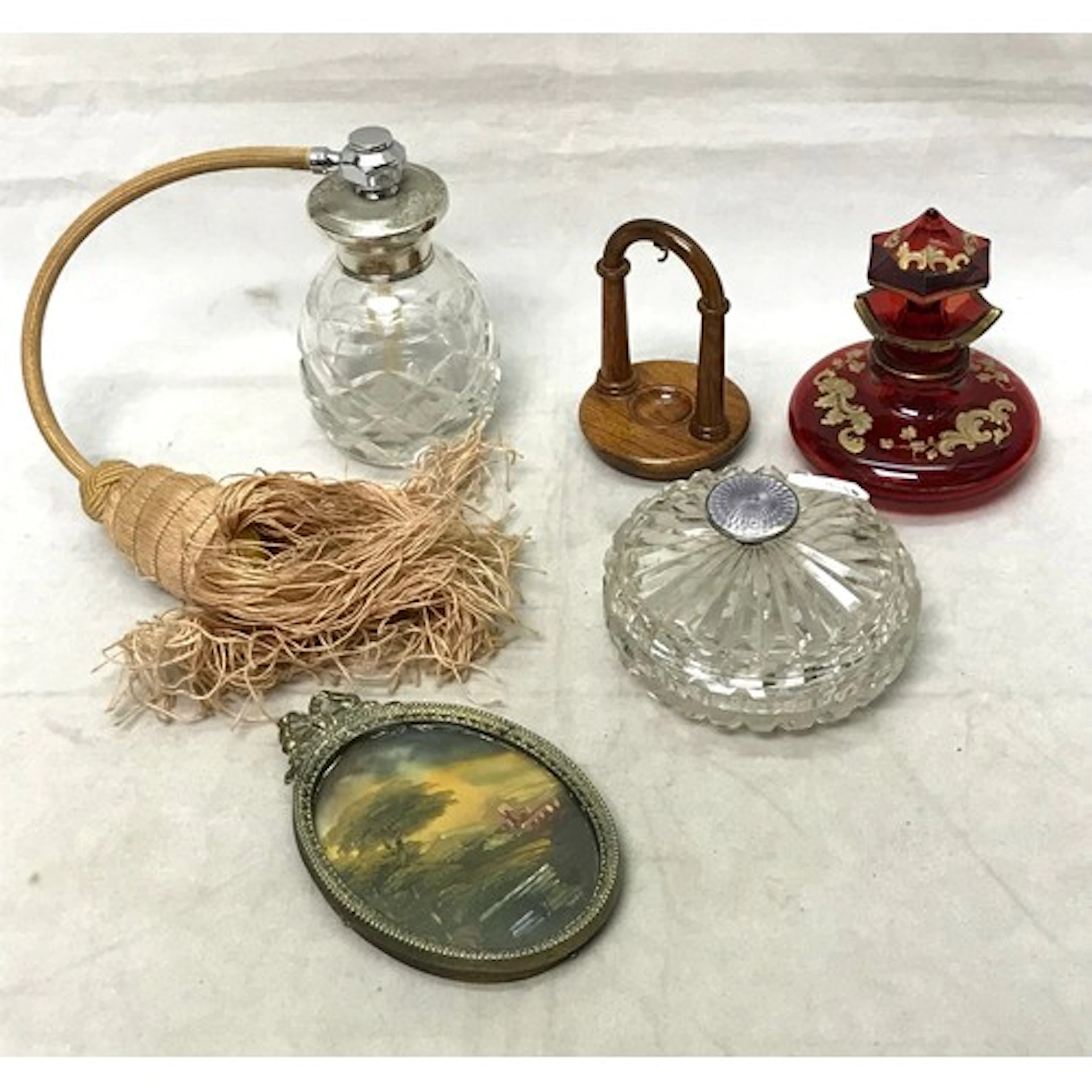 A cut glass perfume atomiser having a white metal collared t...