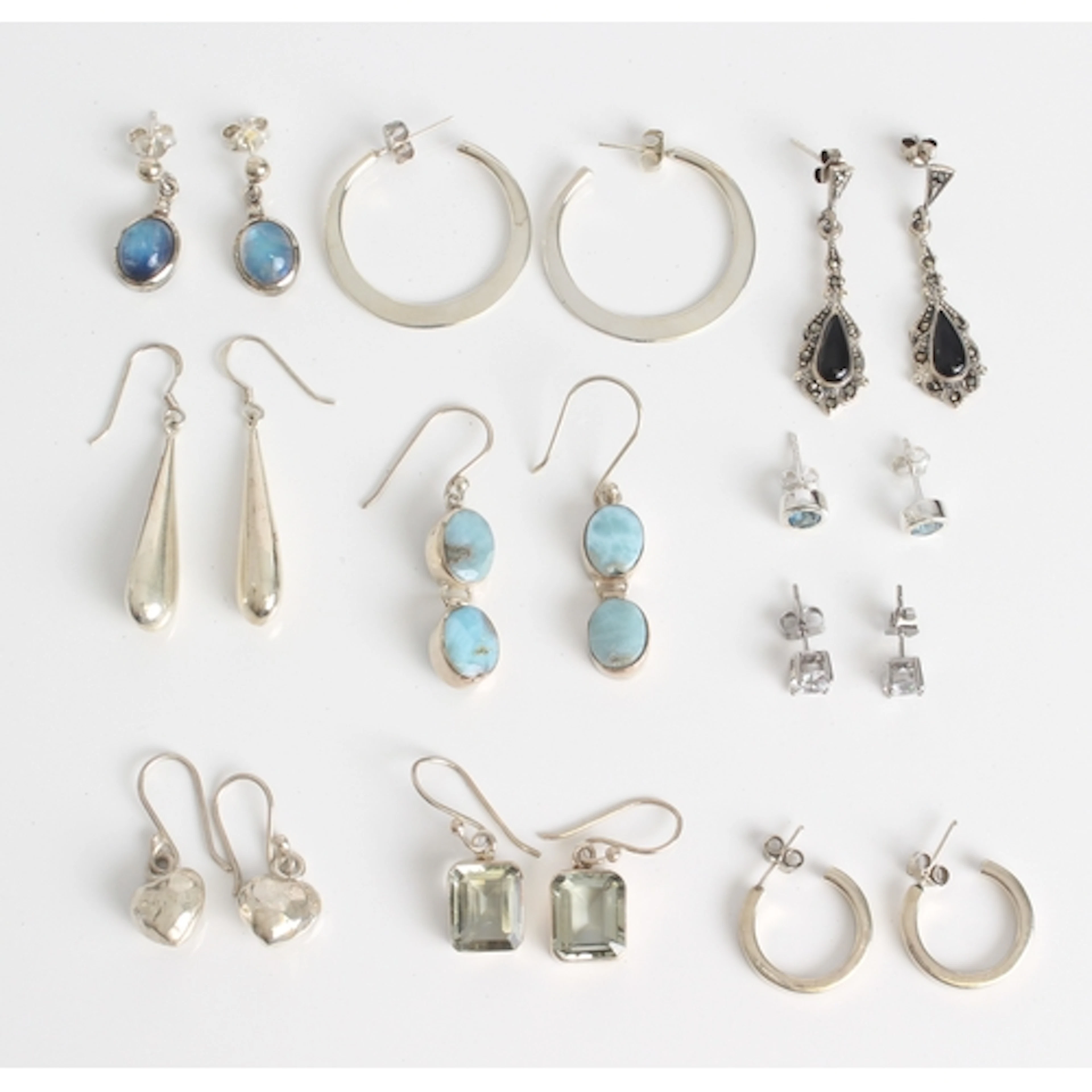 Ten pairs of sterling silver earrings, some set with gemston...