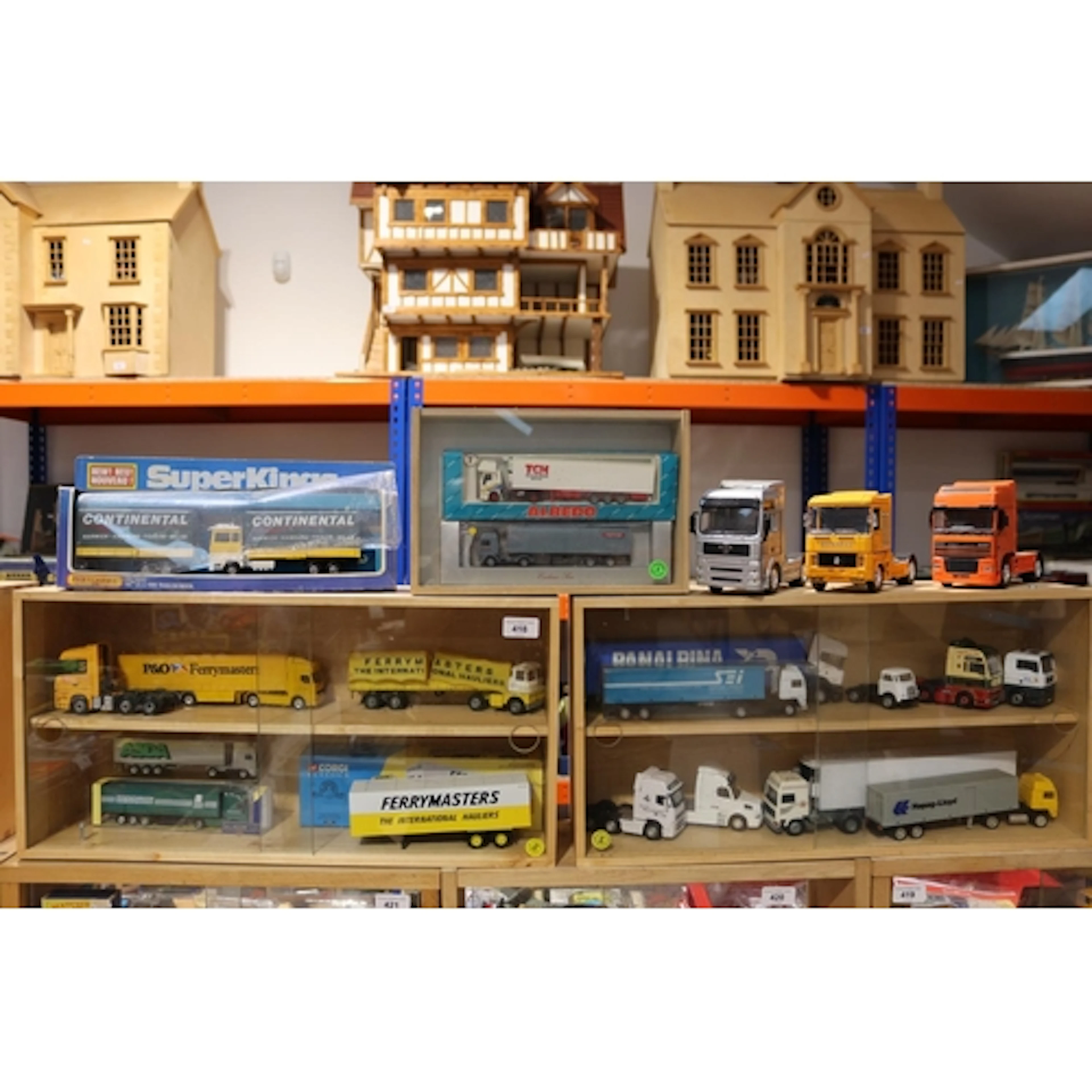 Two wooden wall display shelves containing diecast articulat...