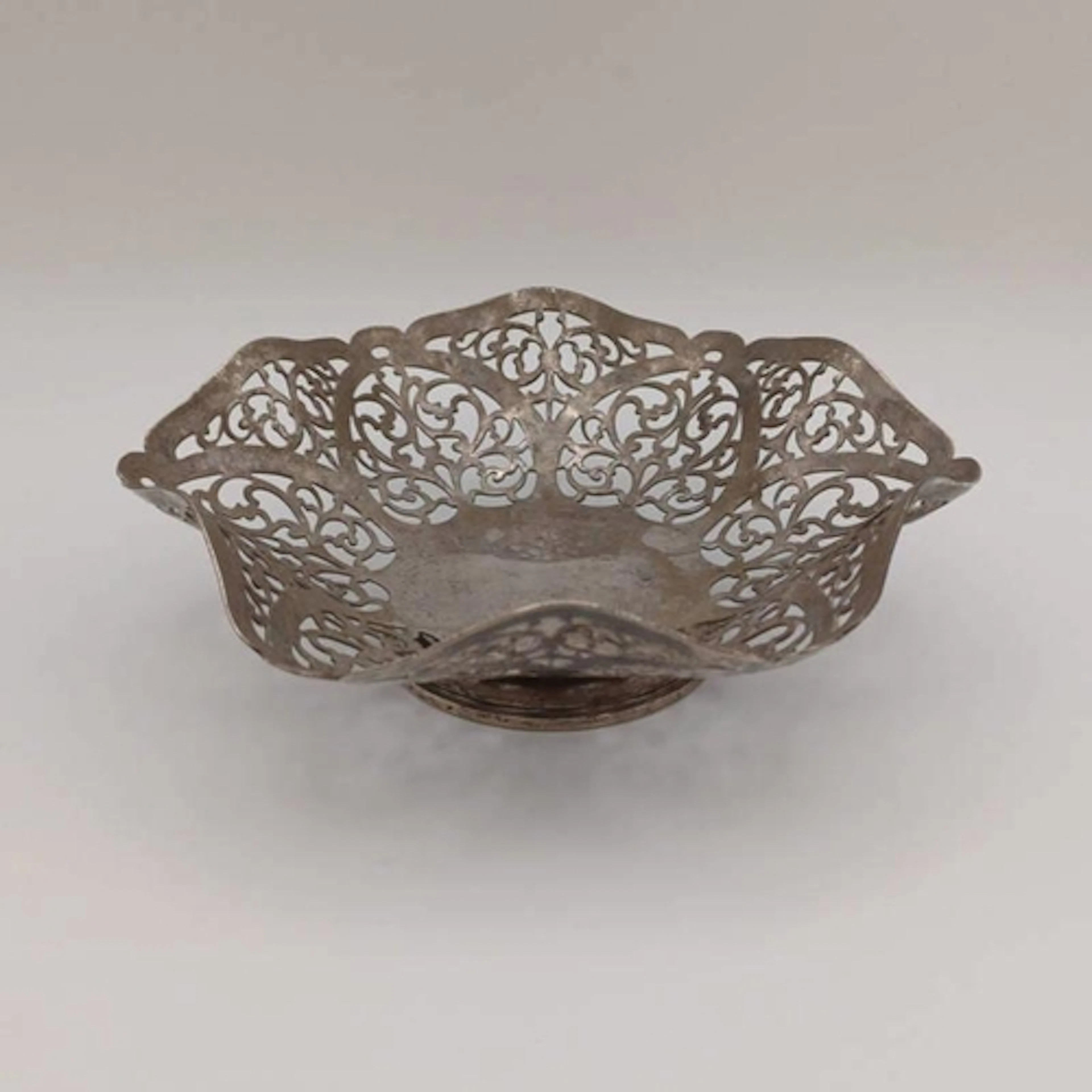 A SILVER BON BON DISH WITH PIERCED DECORATION ON PEDESTAL FO...