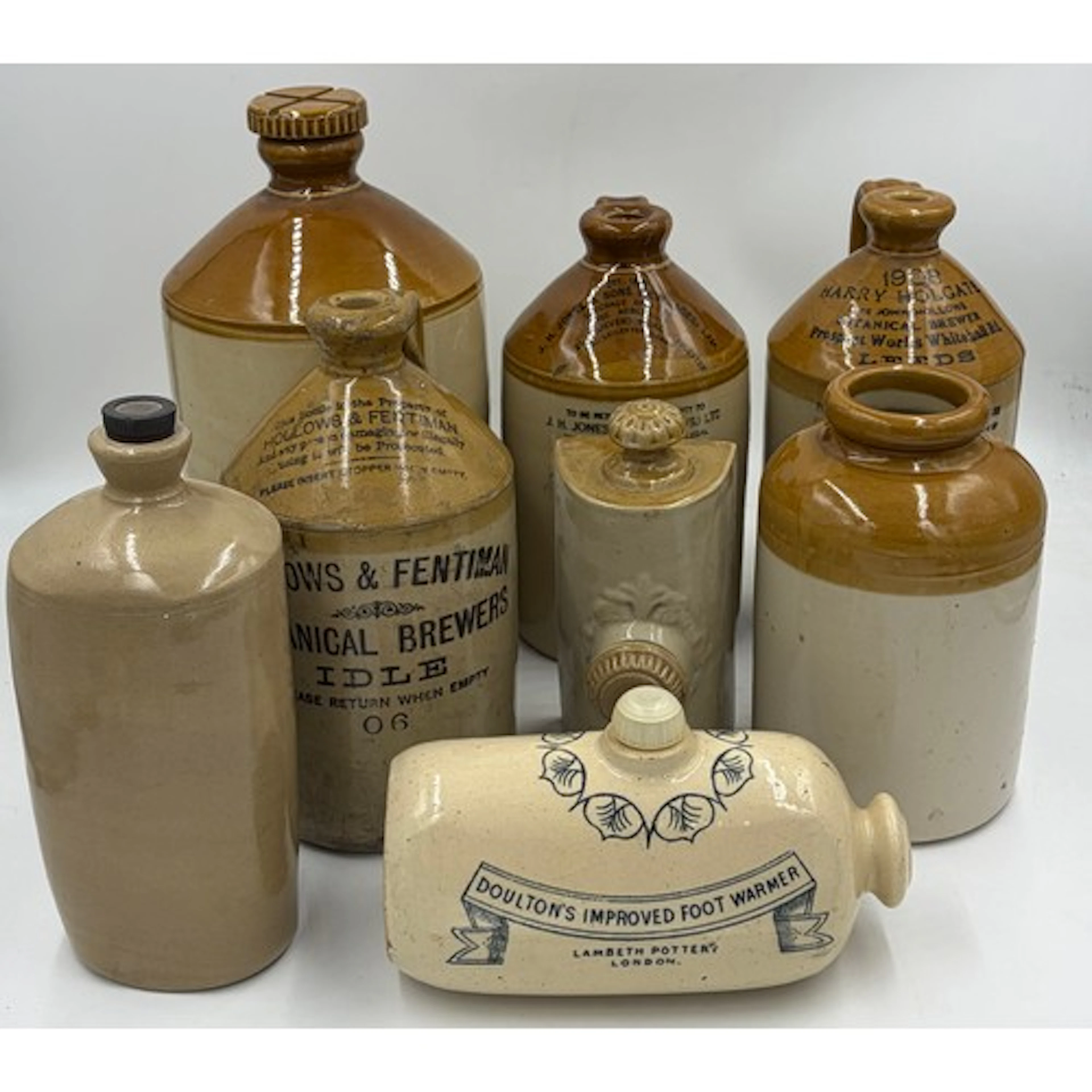 A collection of stoneware bottles to include: J.H.Jones & So...