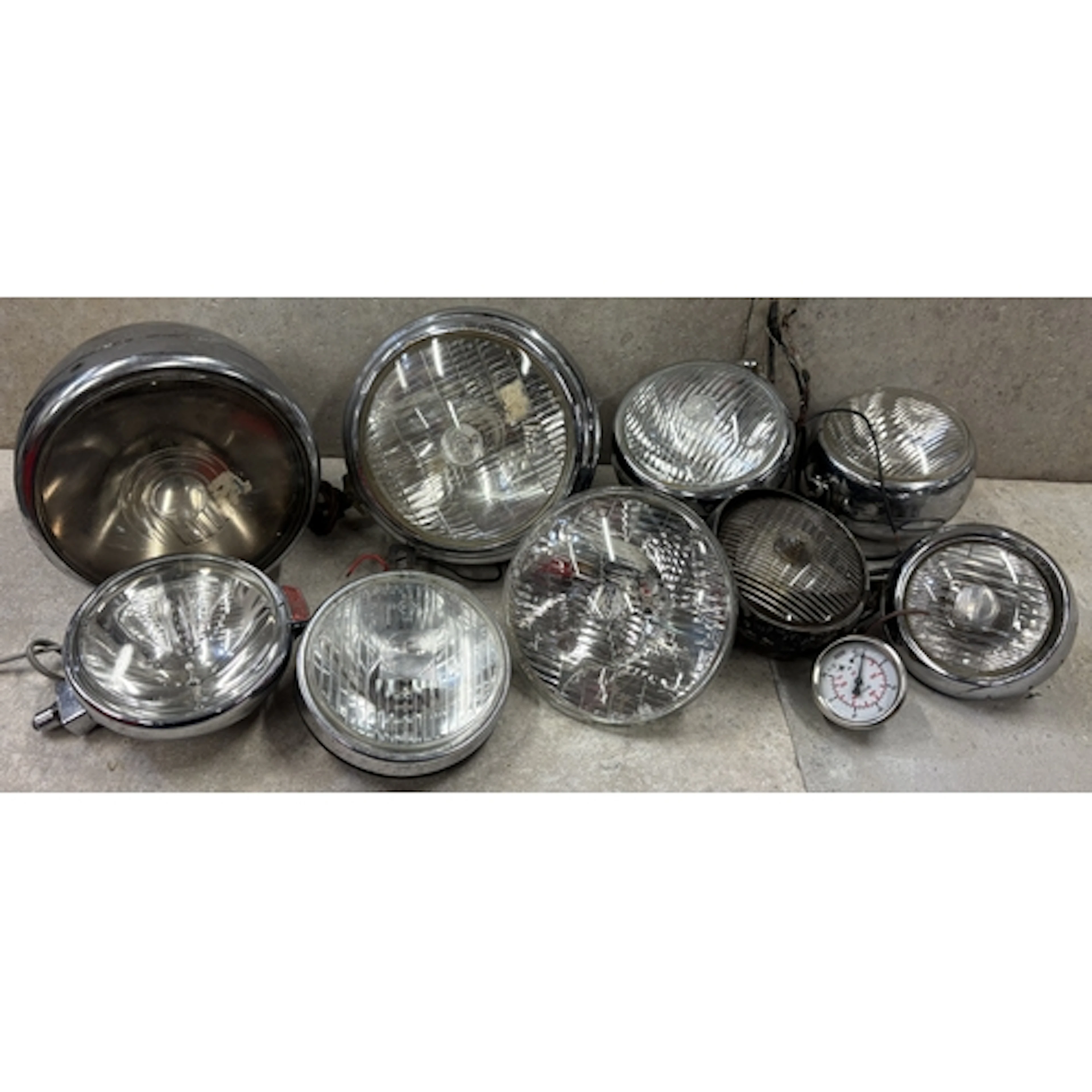 A Lucas M141 headlight together with various other Lucas spo...