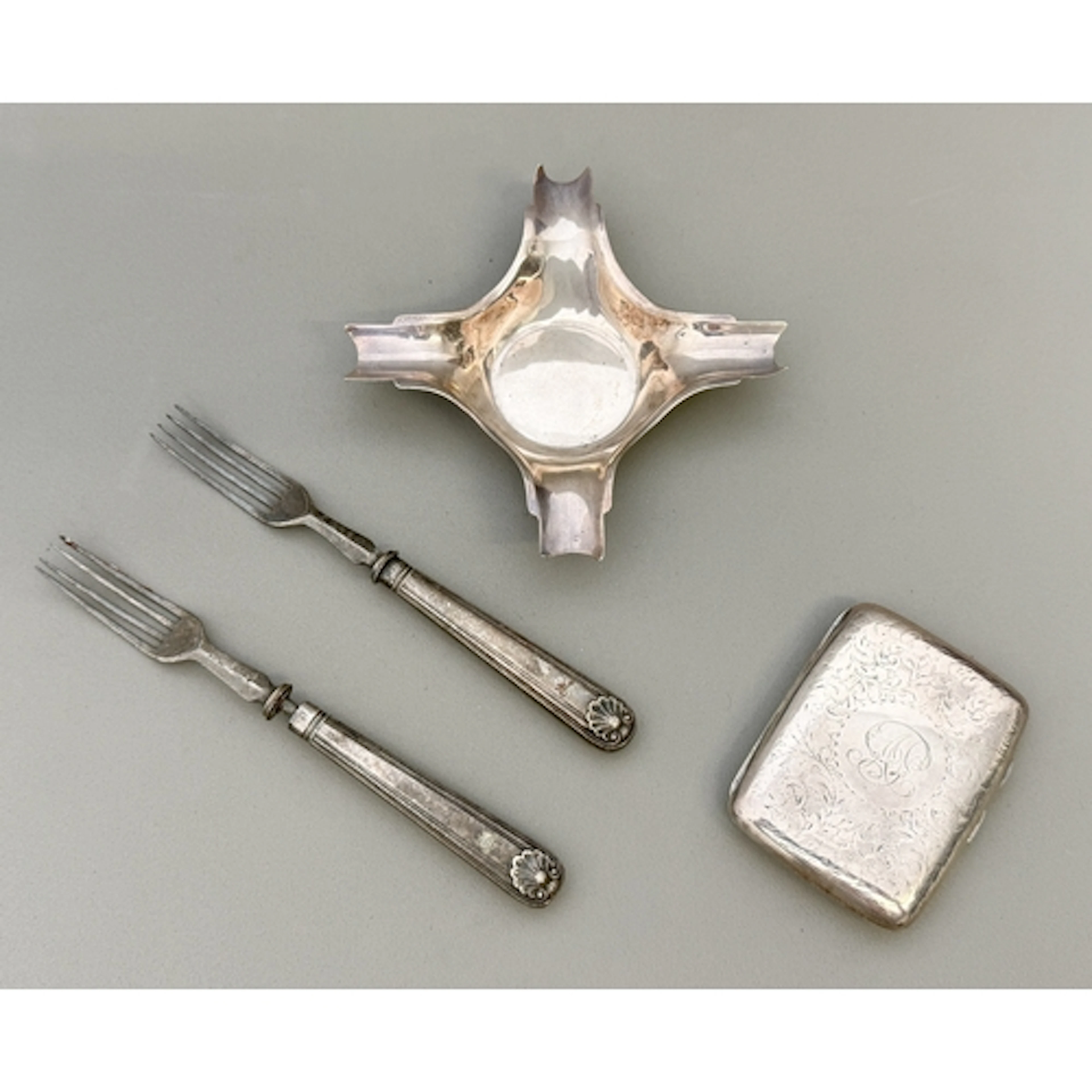 A George V silver cigarette case - with engraved foliate des...