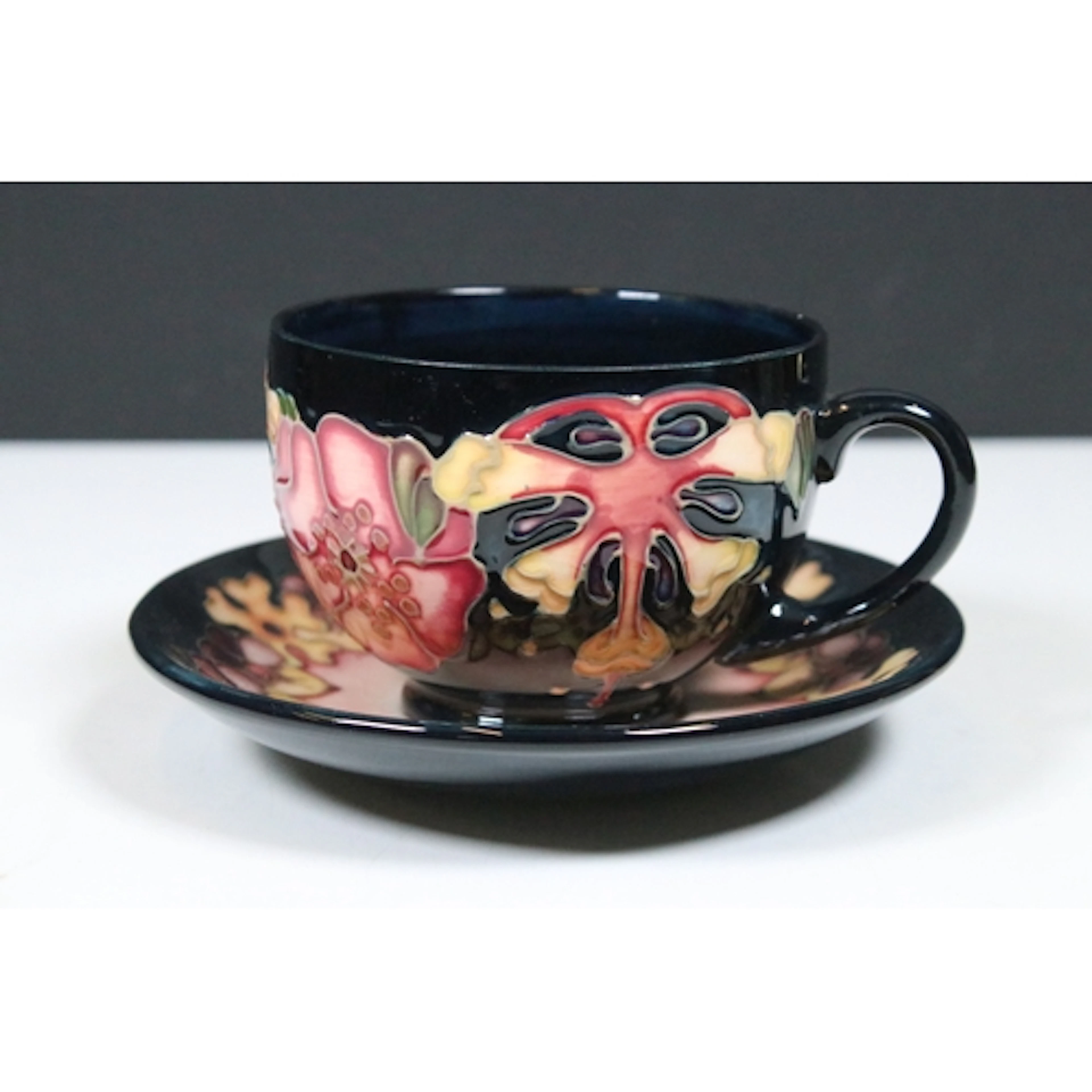 Moorcroft pottery 'Oberon' pattern tea cup and saucer, desig...