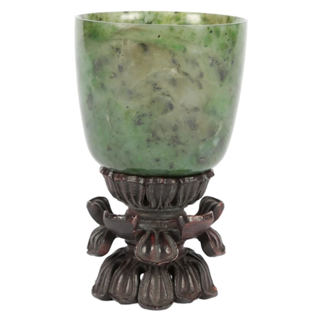 A Chinese spinach green jade cup, 18th century, the gently c...
