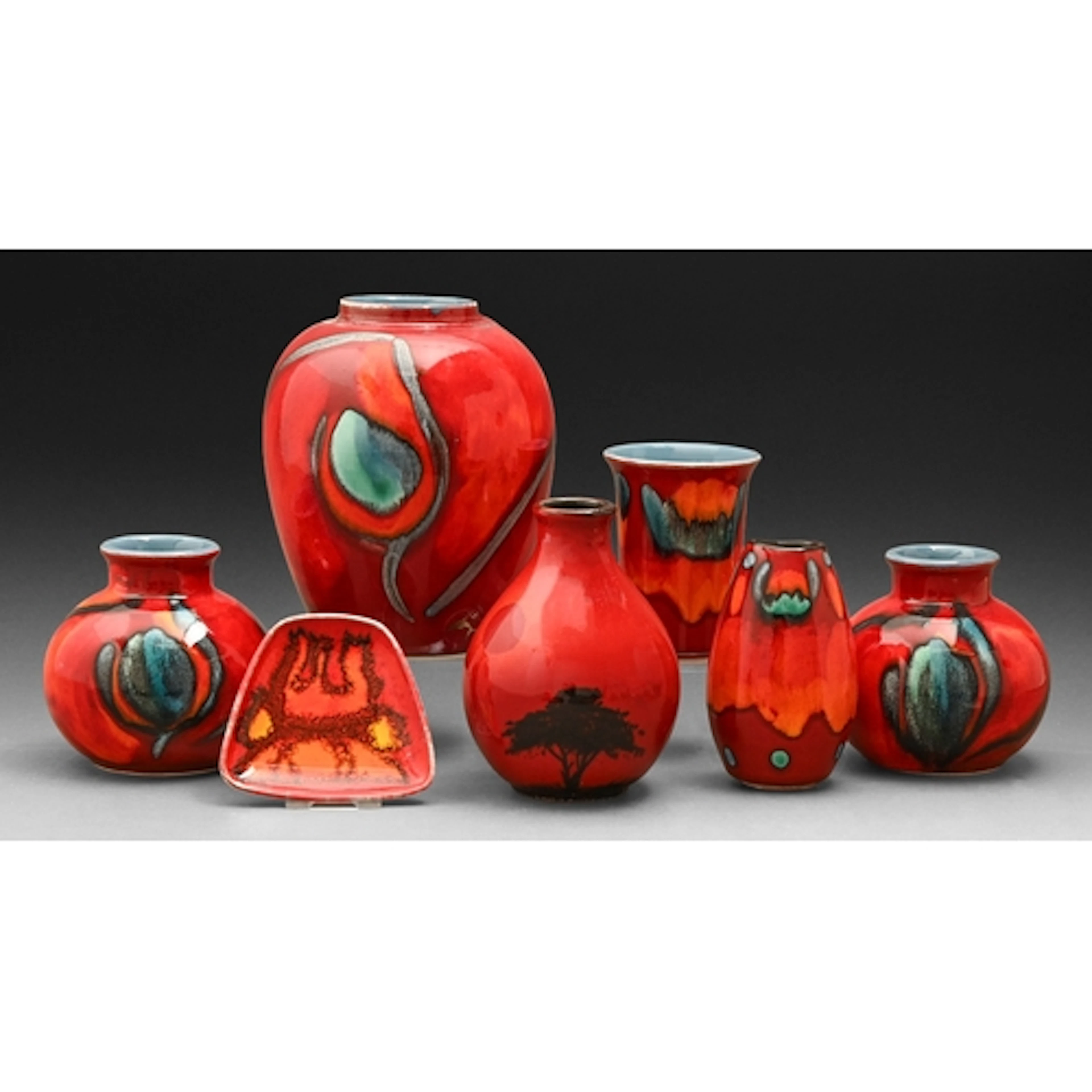 Six Poole Pottery 'Volcano' and 'African Sky' vases and a di...