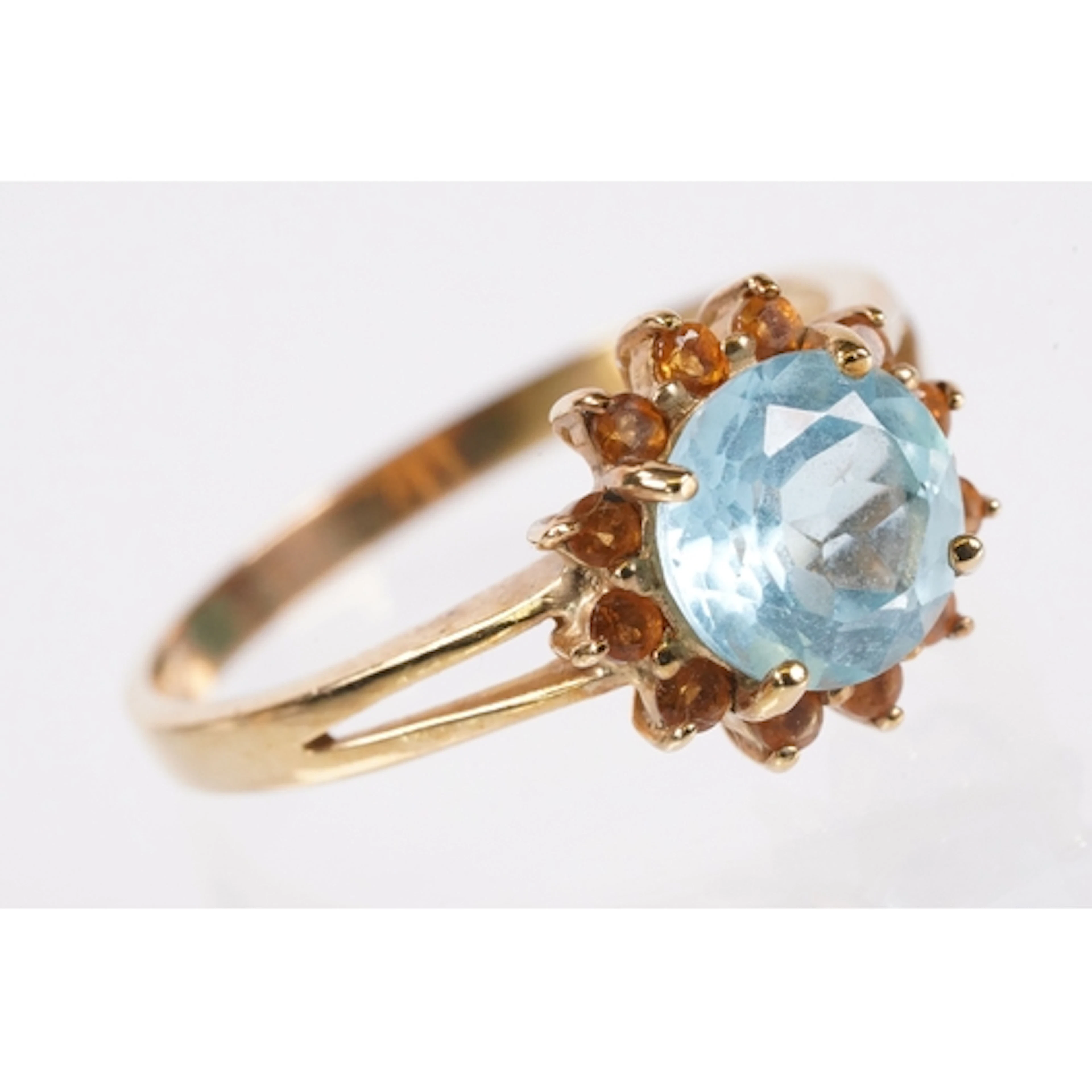 9ct gold, topaz and citrine dress ring. The ring being set w...
