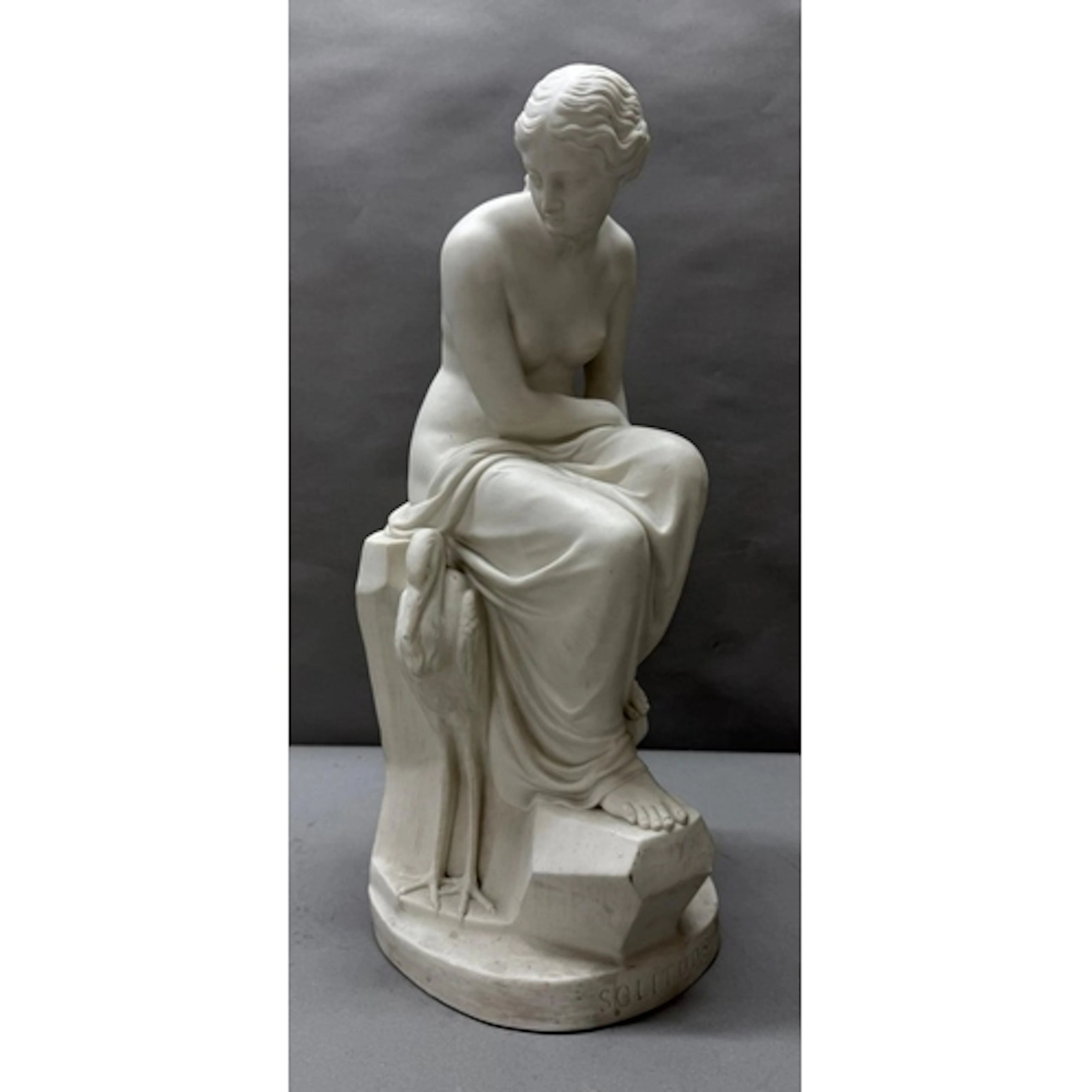 A Minton Parian porcelain figure of a seated lady with a her...