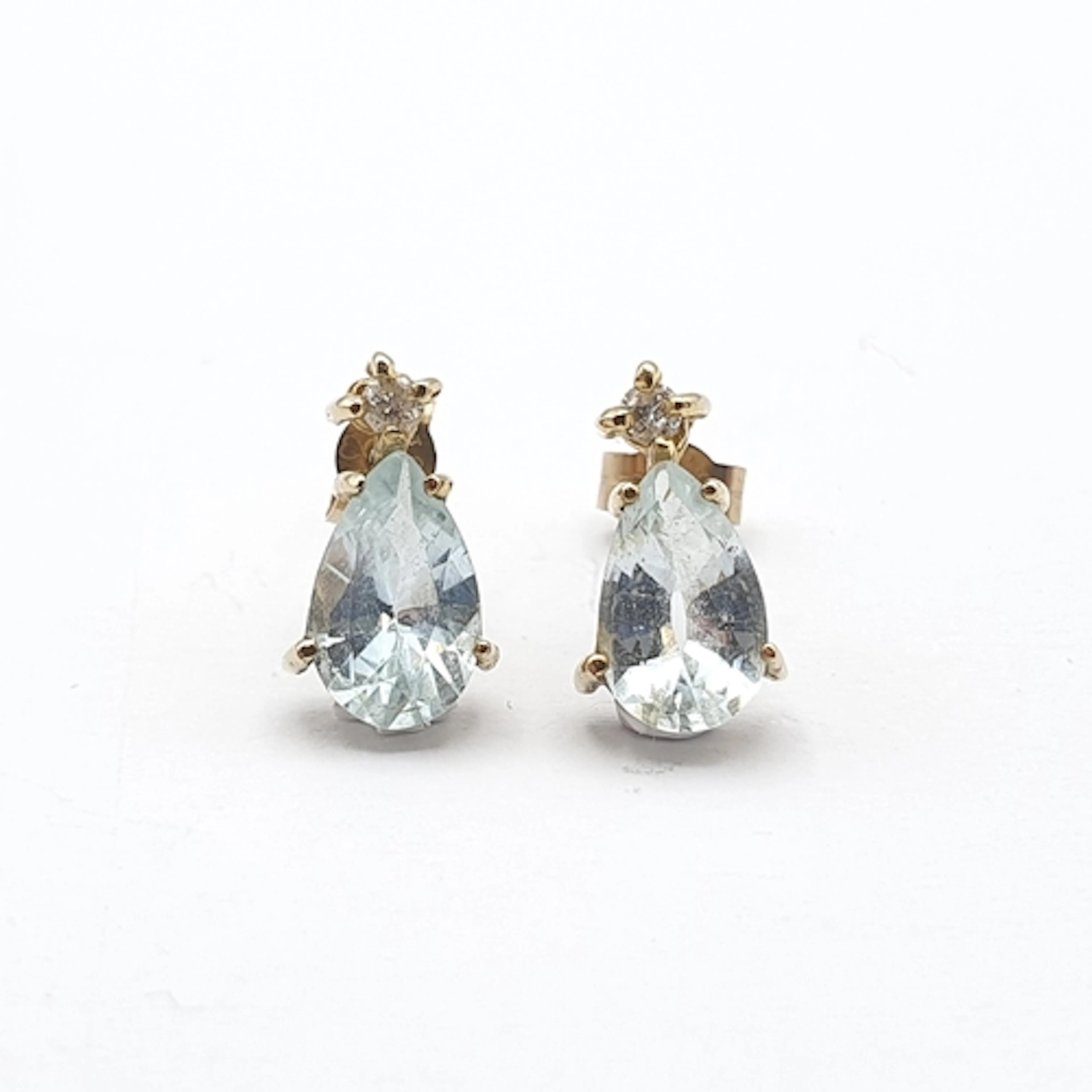 A pair of Aquamarine and Diamond Earrings, claw-set pear-sha...