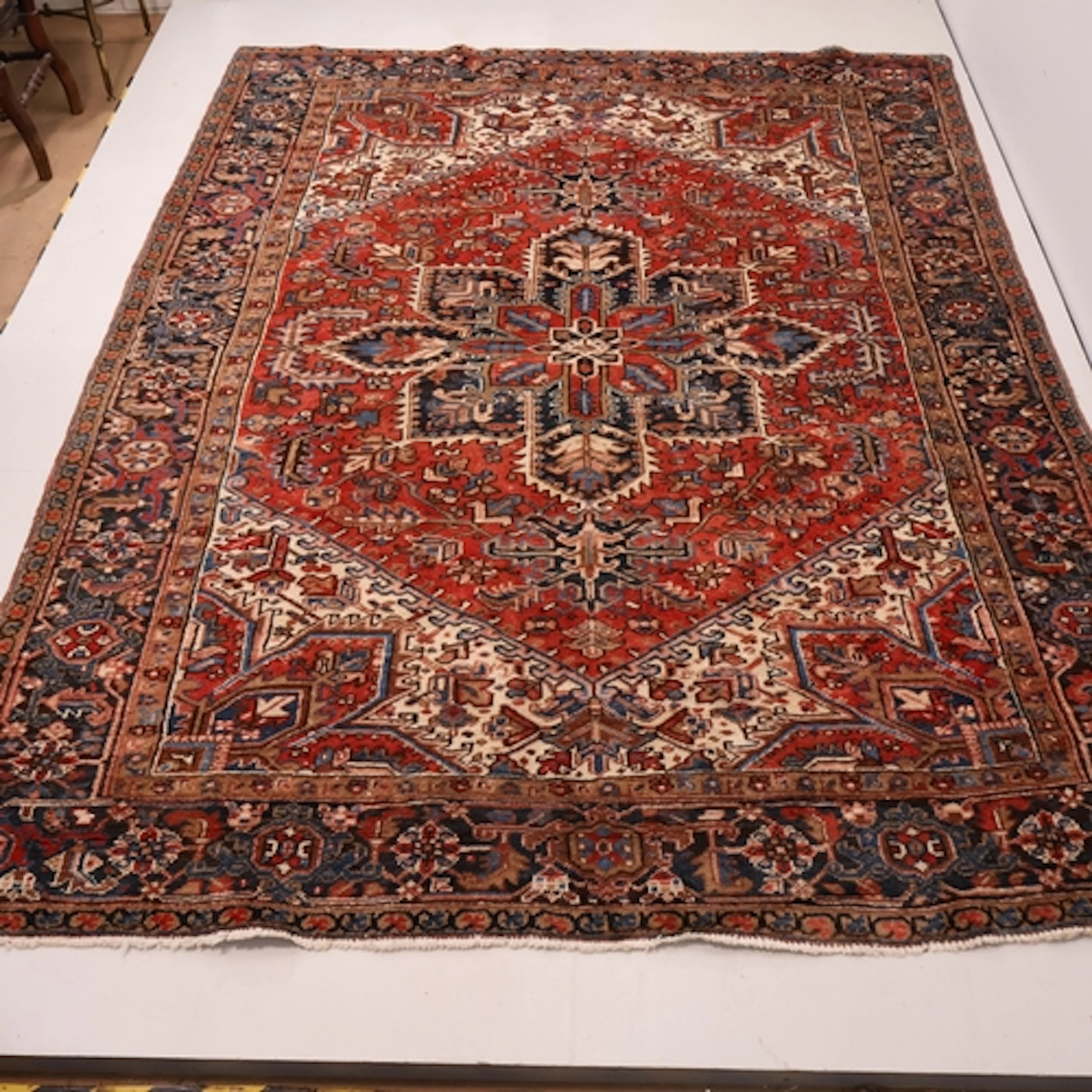 A large red ground Persian Heriz carpet, L290cm, W215cm.