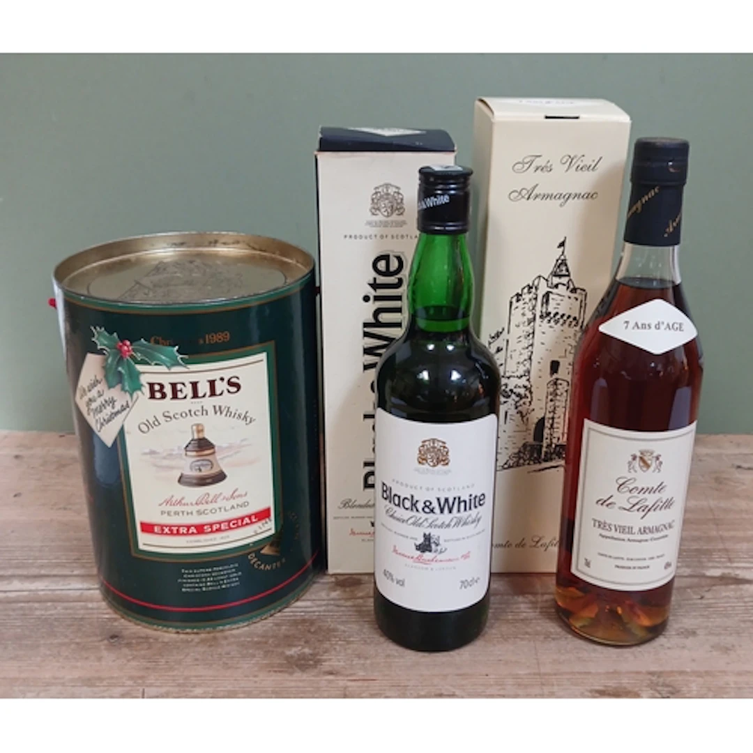 Three assorted bottles; Black & White blended scotch whisky,...