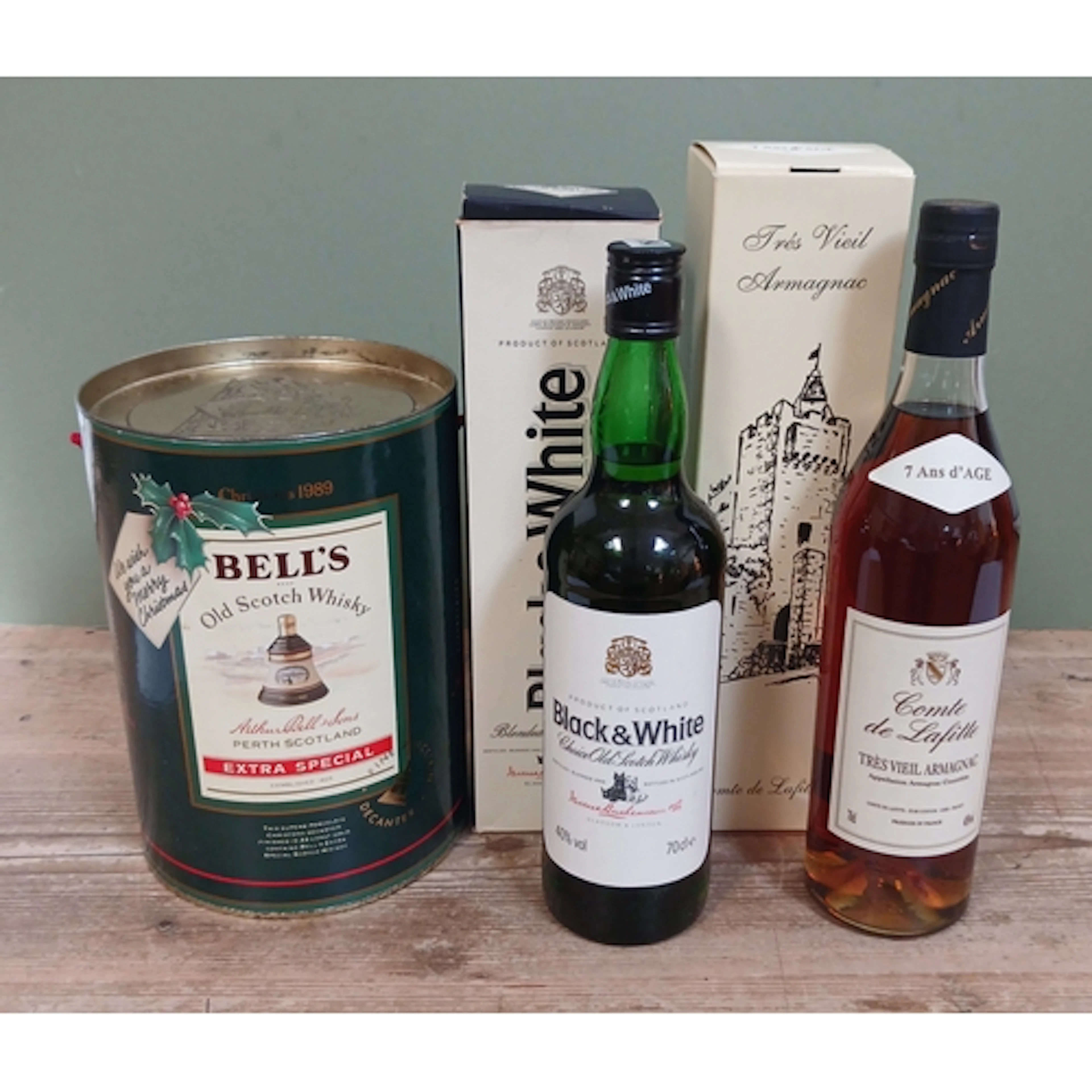 Three assorted bottles; Black & White blended scotch whisky,...