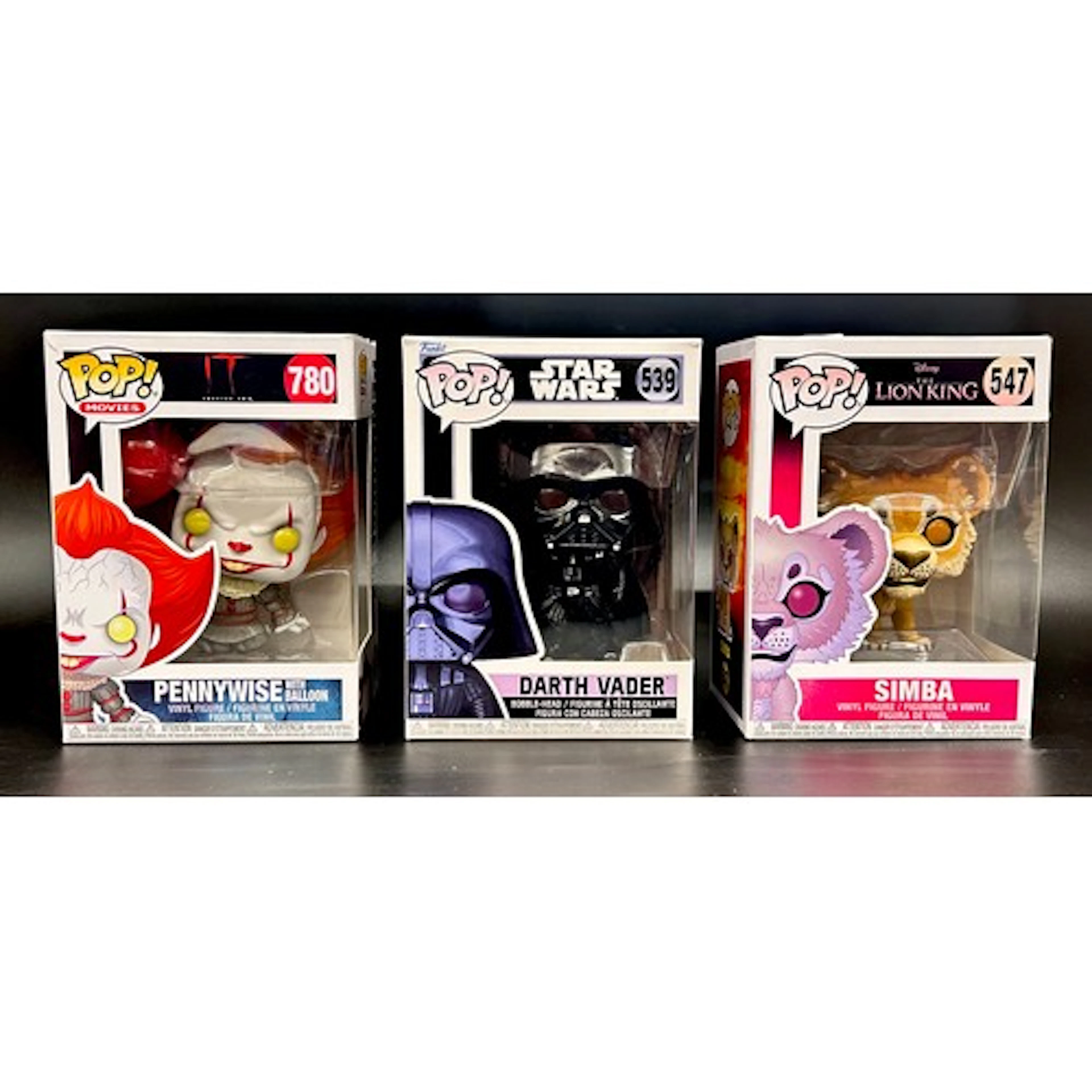 Three Funko pop figures; Simba, Darth Vader and Pennywise, b...