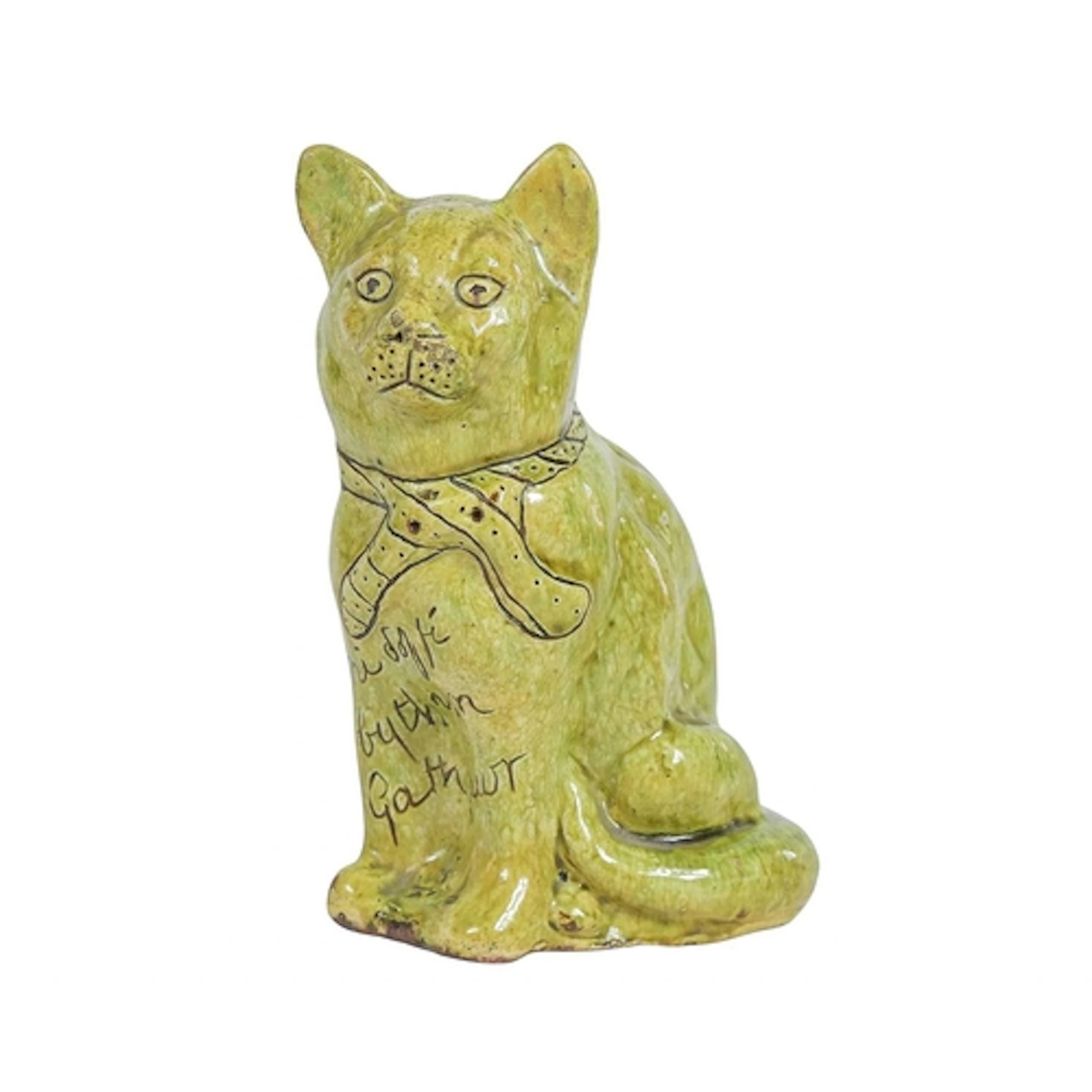 A green glazed Ewenny cat. Circa 1910, with incised decorati...