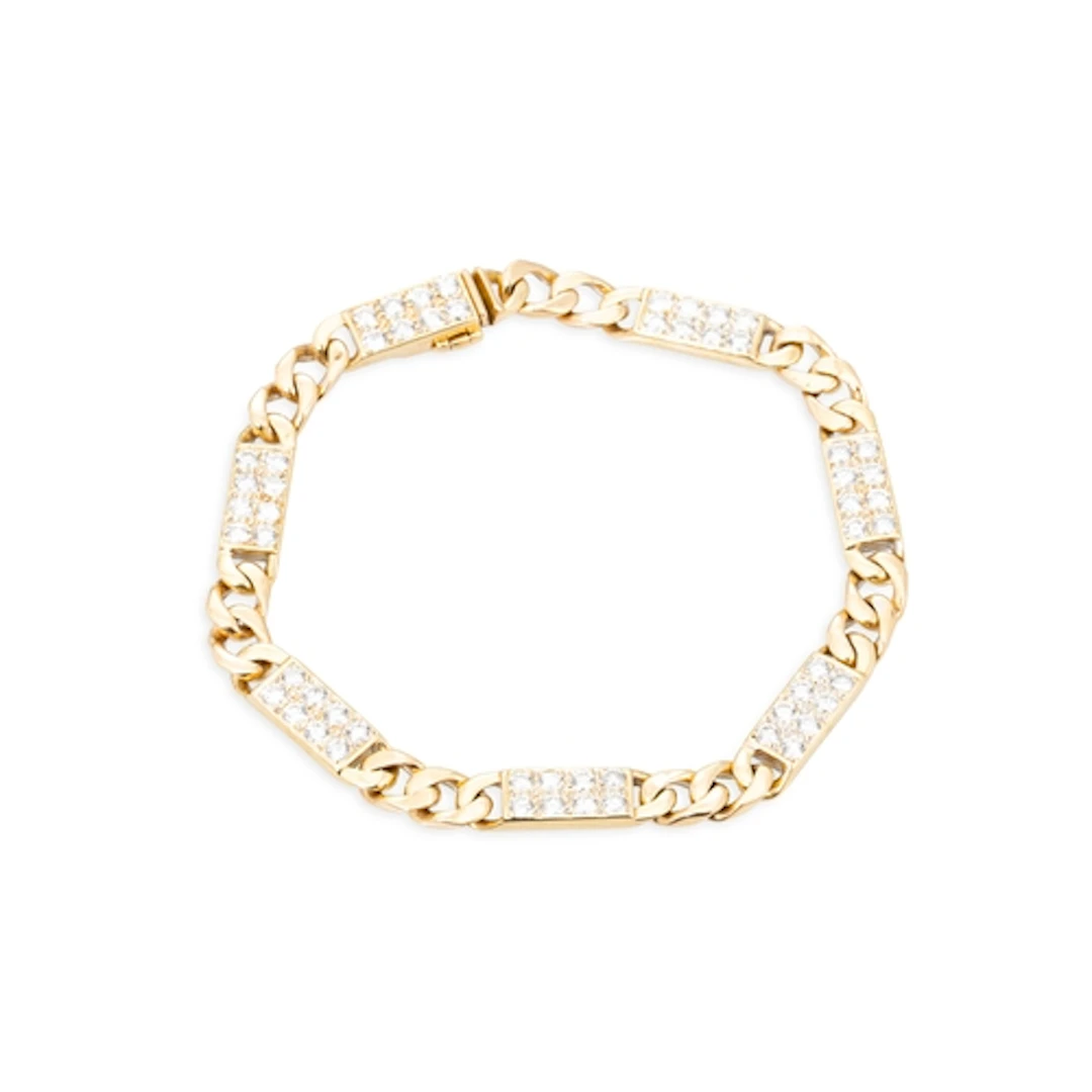 A DIAMOND SET CURB LINK BRACELET, comprising pavé set panels...