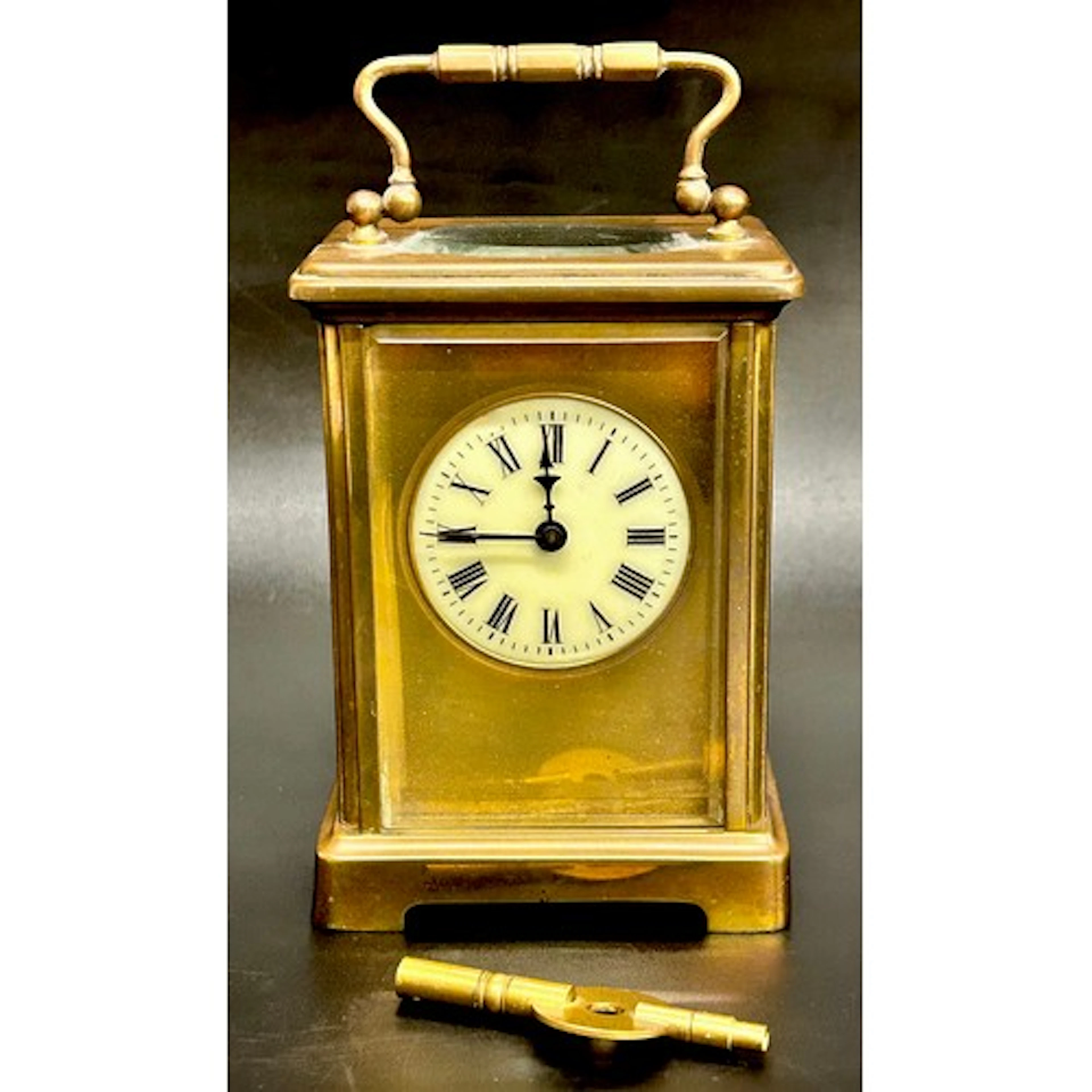 A brass carriage clock with enamel face, with key, 11.5cm h