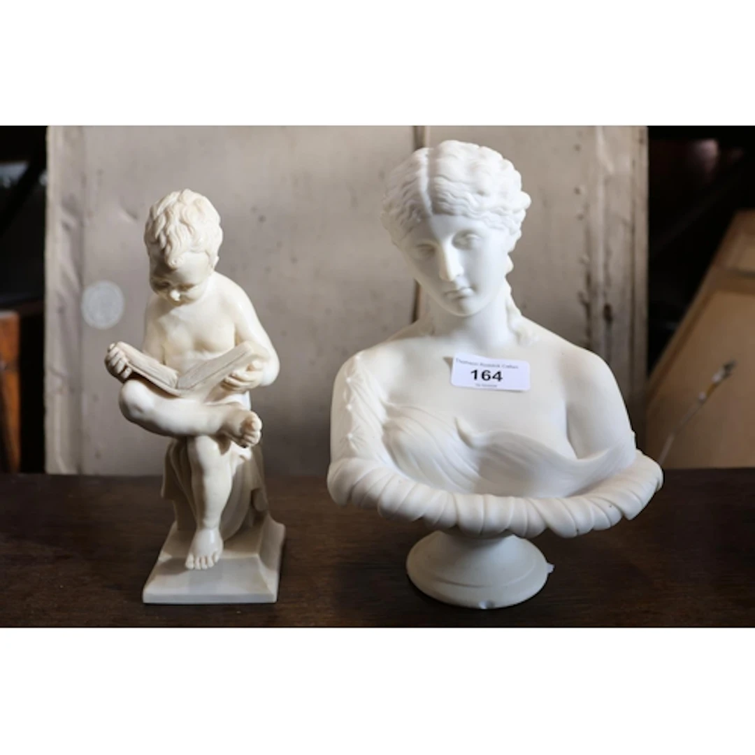 Bust figure of a maiden and a figure of a boy reading.