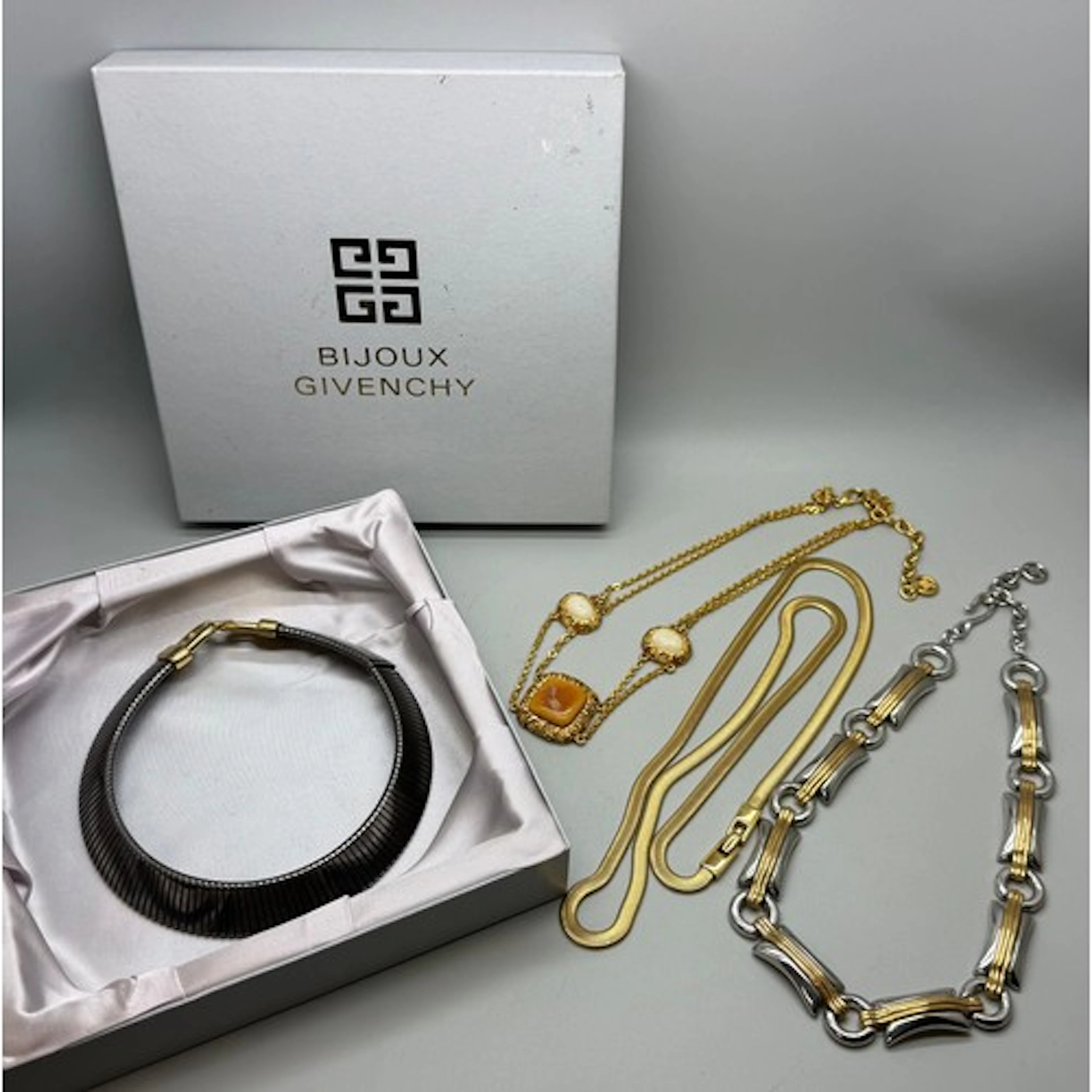 A collection of four Givenchy designer costume necklaces