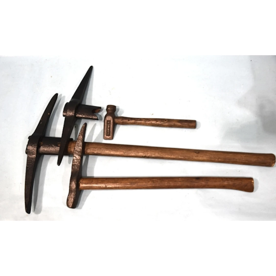 A coal miner's pickaxe, a pickaxe head, another pick and a h...