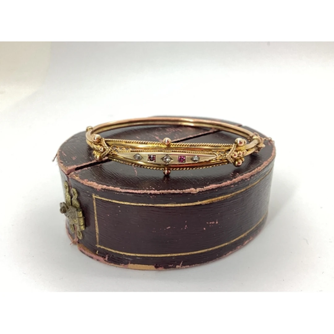 An Edwardian Ruby and Diamond Set Hinged Bangle, of intricat...