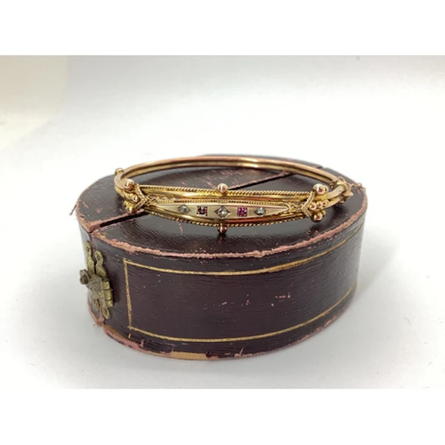An Edwardian Ruby and Diamond Set Hinged Bangle, of intricat...