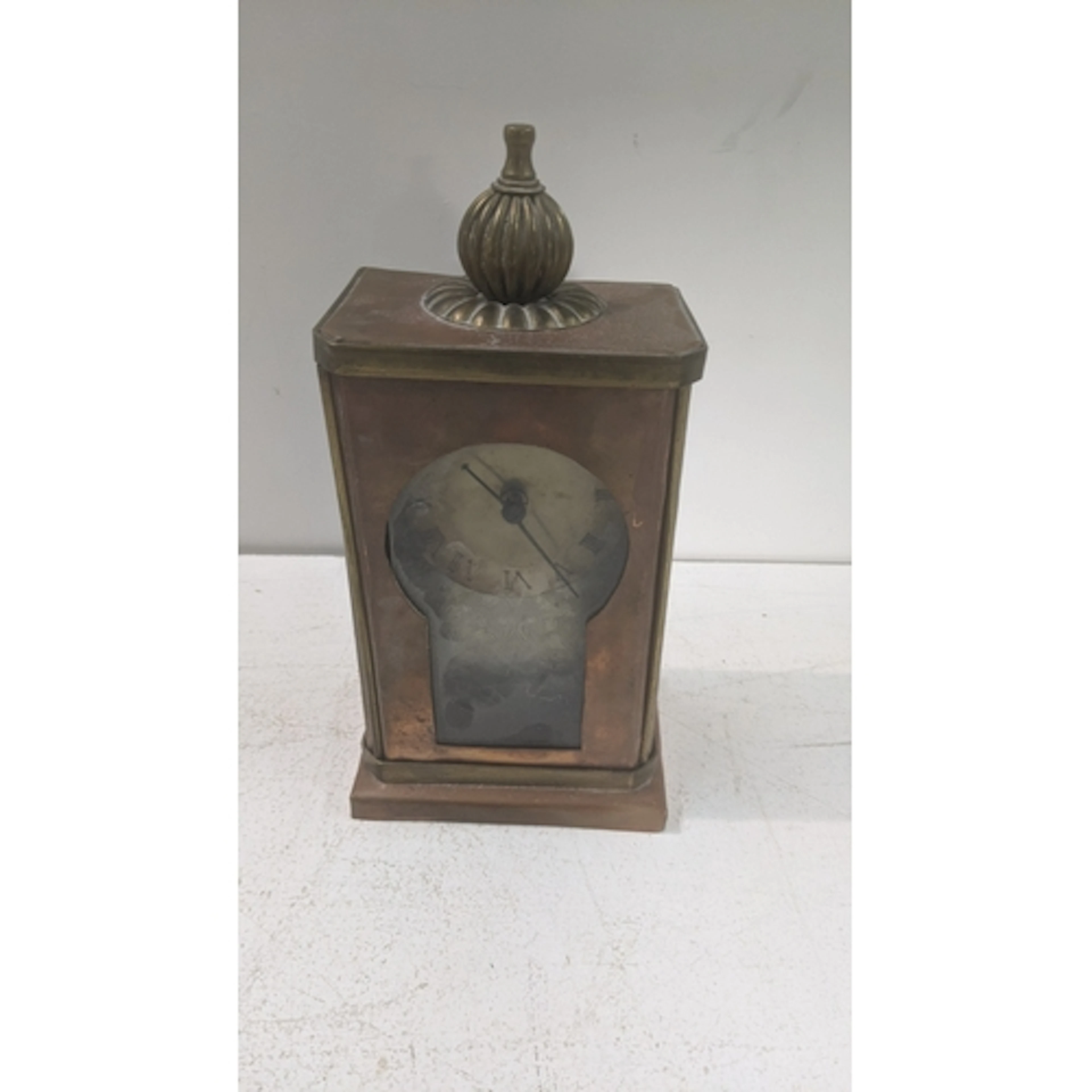 An arts and crafts copper and brass framed mantle clock havi...
