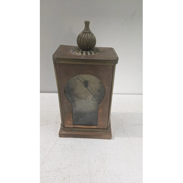 An arts and crafts copper and brass framed mantle clock havi...