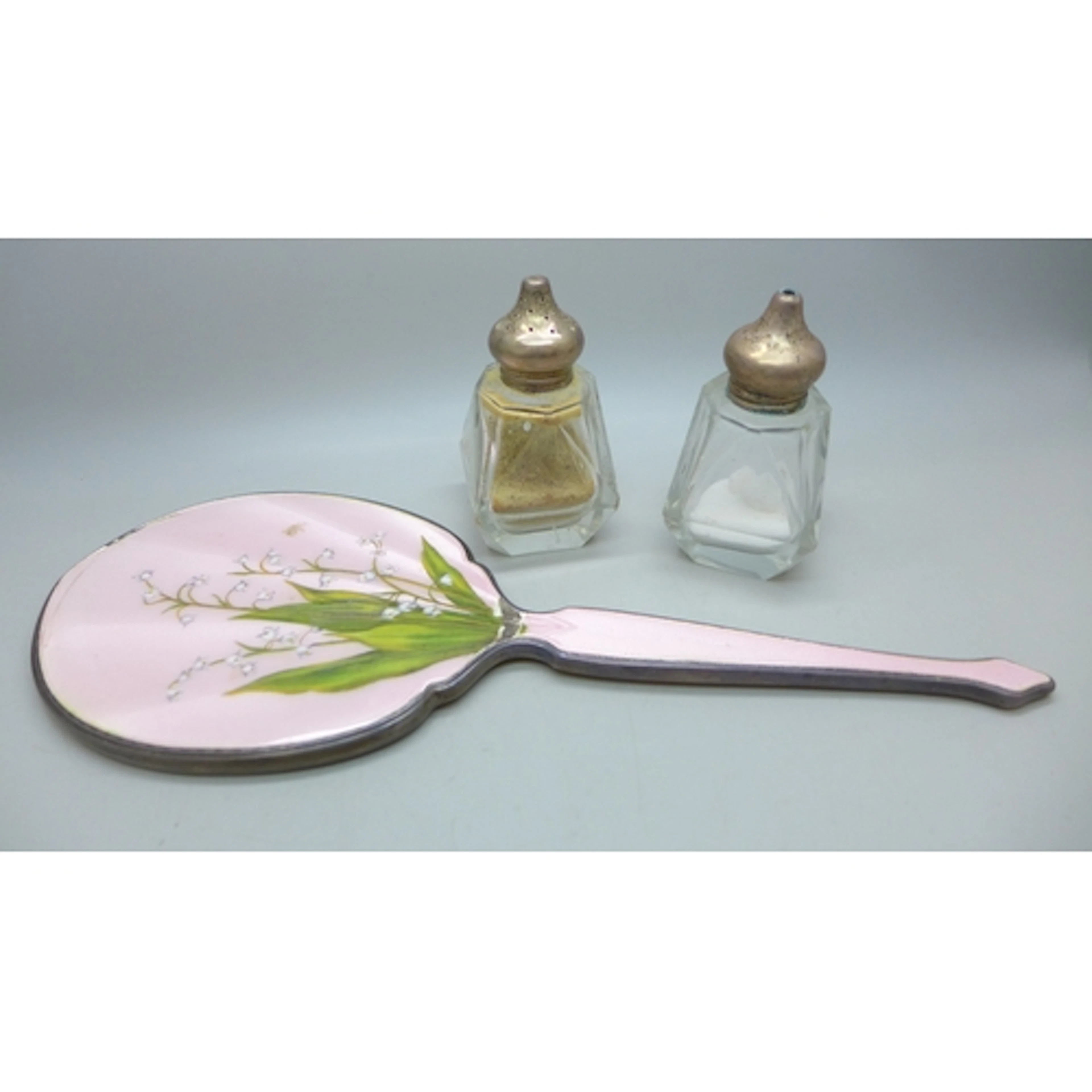 A silver hand mirror with floral guilloche enamel decoration...