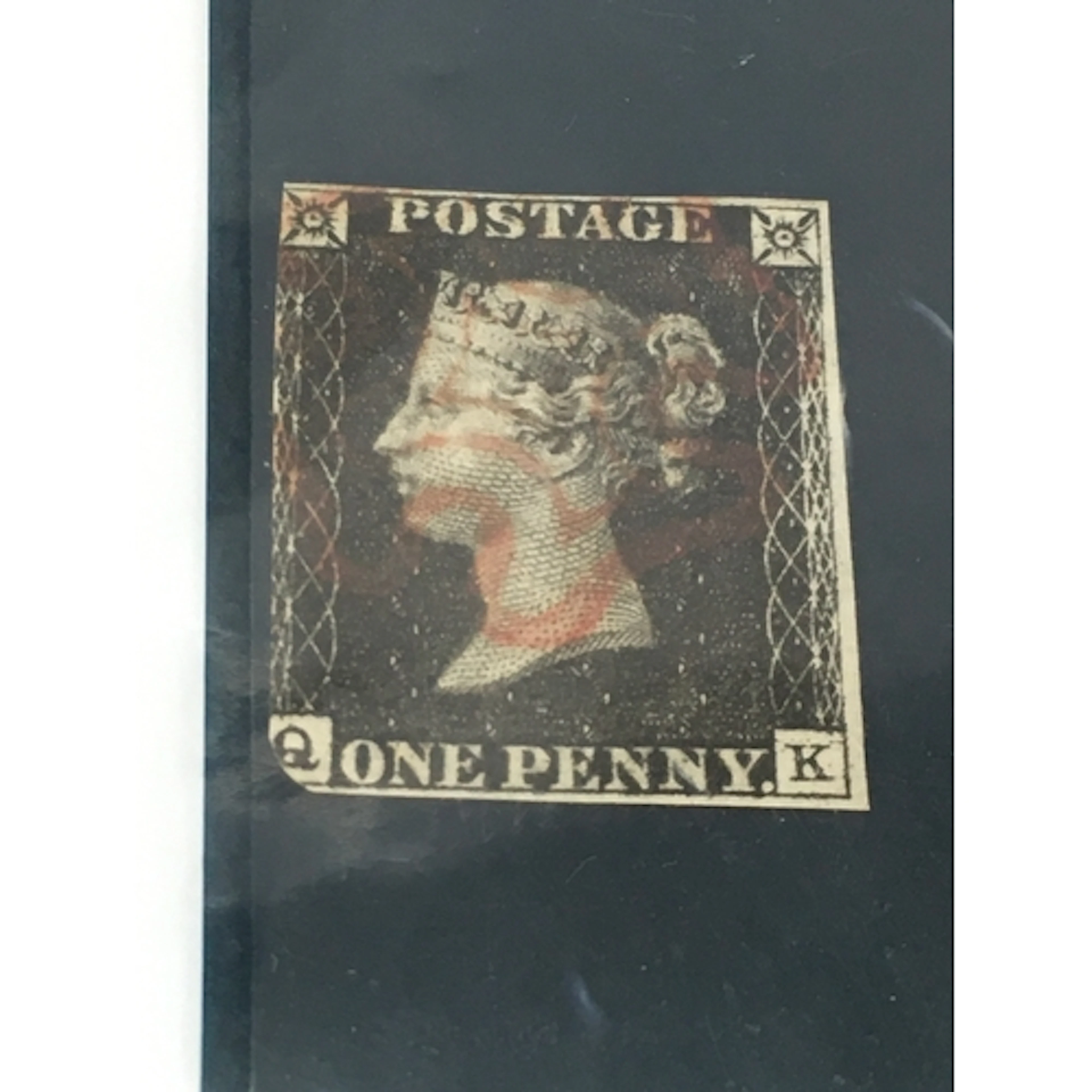 1840s Queen Victoria One Penny Black postage stamp featuring...