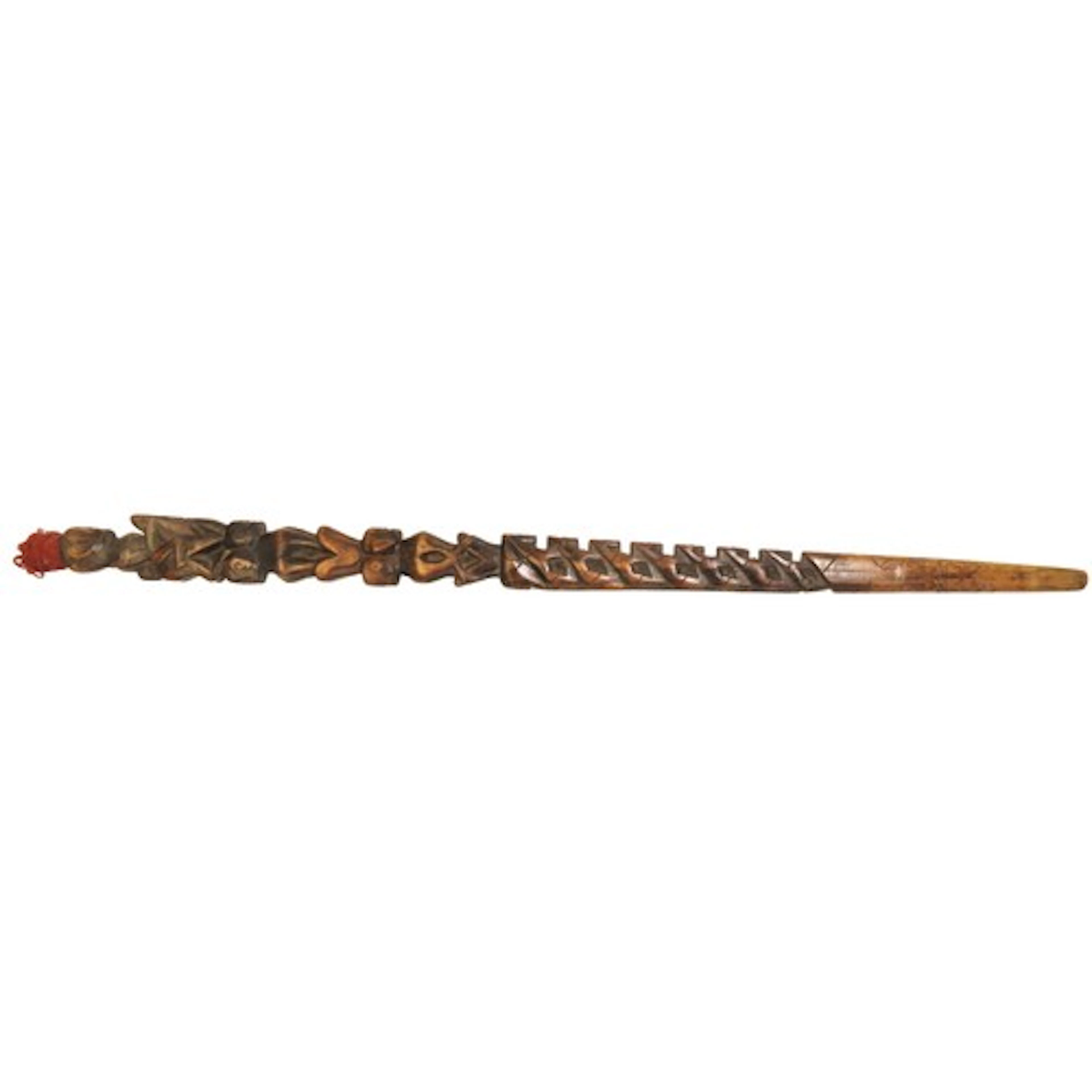 A CHIEFTAN'S STAFF or walking stick carved with a figure ato...