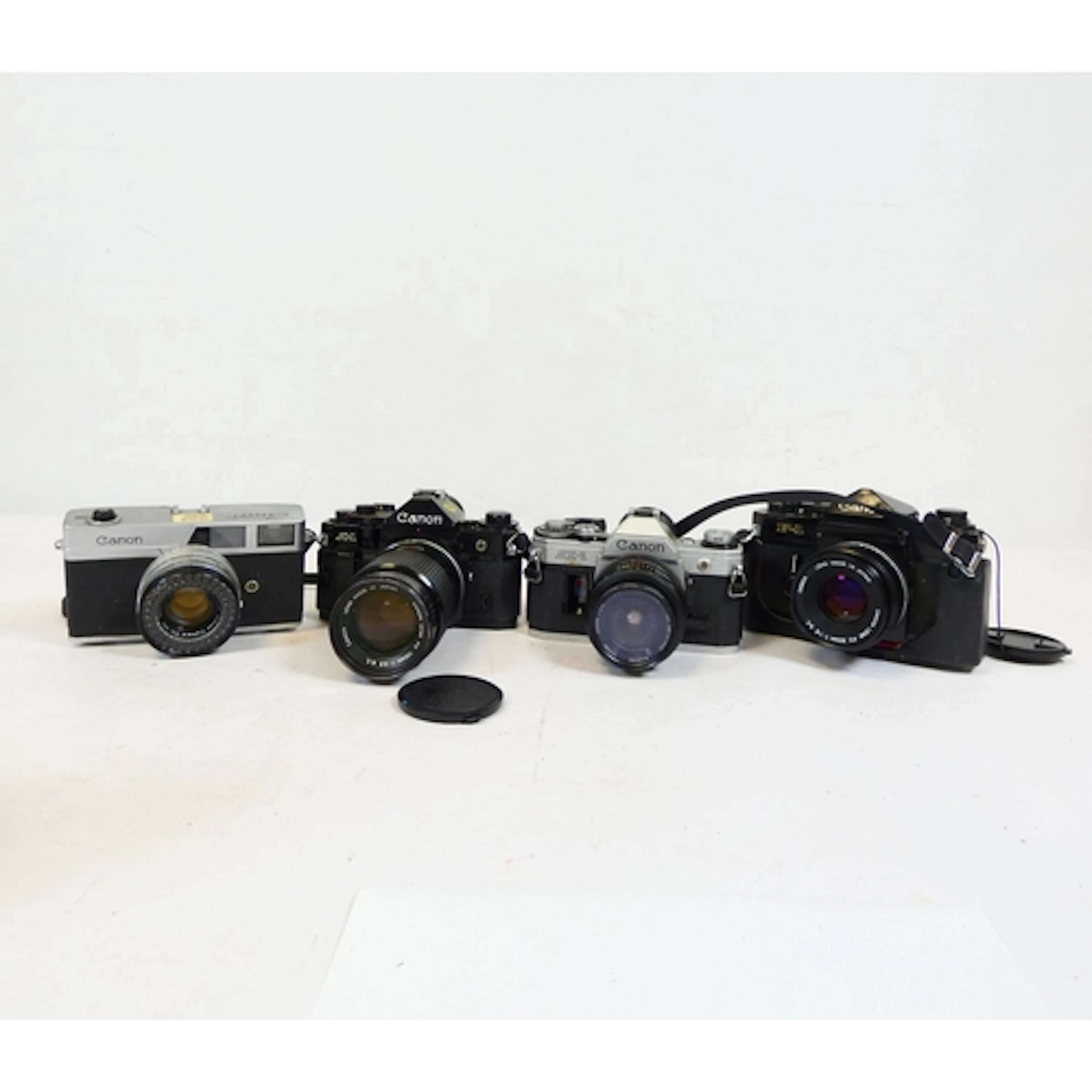 Canon. Four vintage 35mm SLR film cameras to include an F-1 ...
