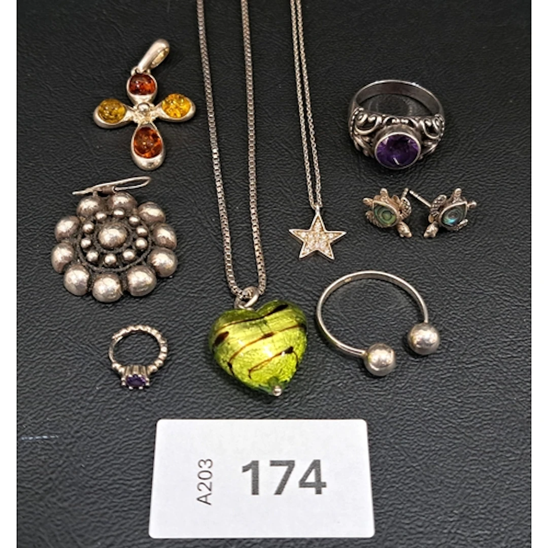 EIGHT PIECES OF SILVER JEWELLERY comprising an amber set pen...