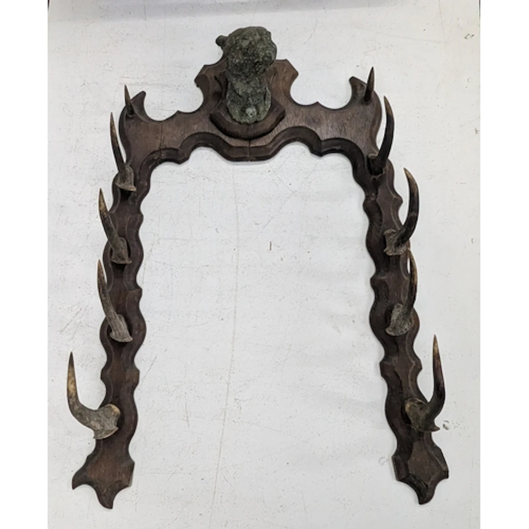 A Victorian antler whip rack with a bulldog head mounted to ...
