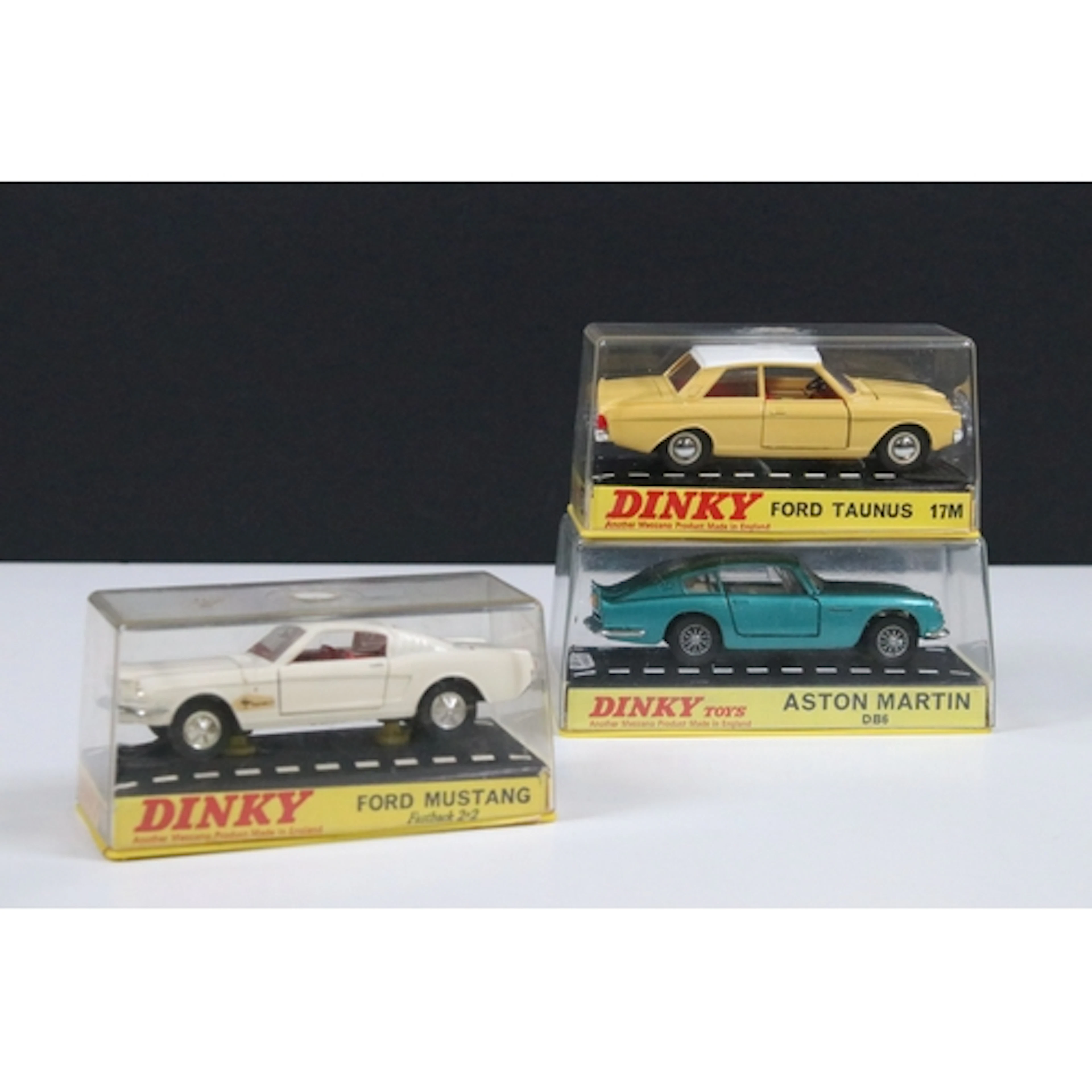 Three cased Dinky diecast models to include 153 Aston Martin...
