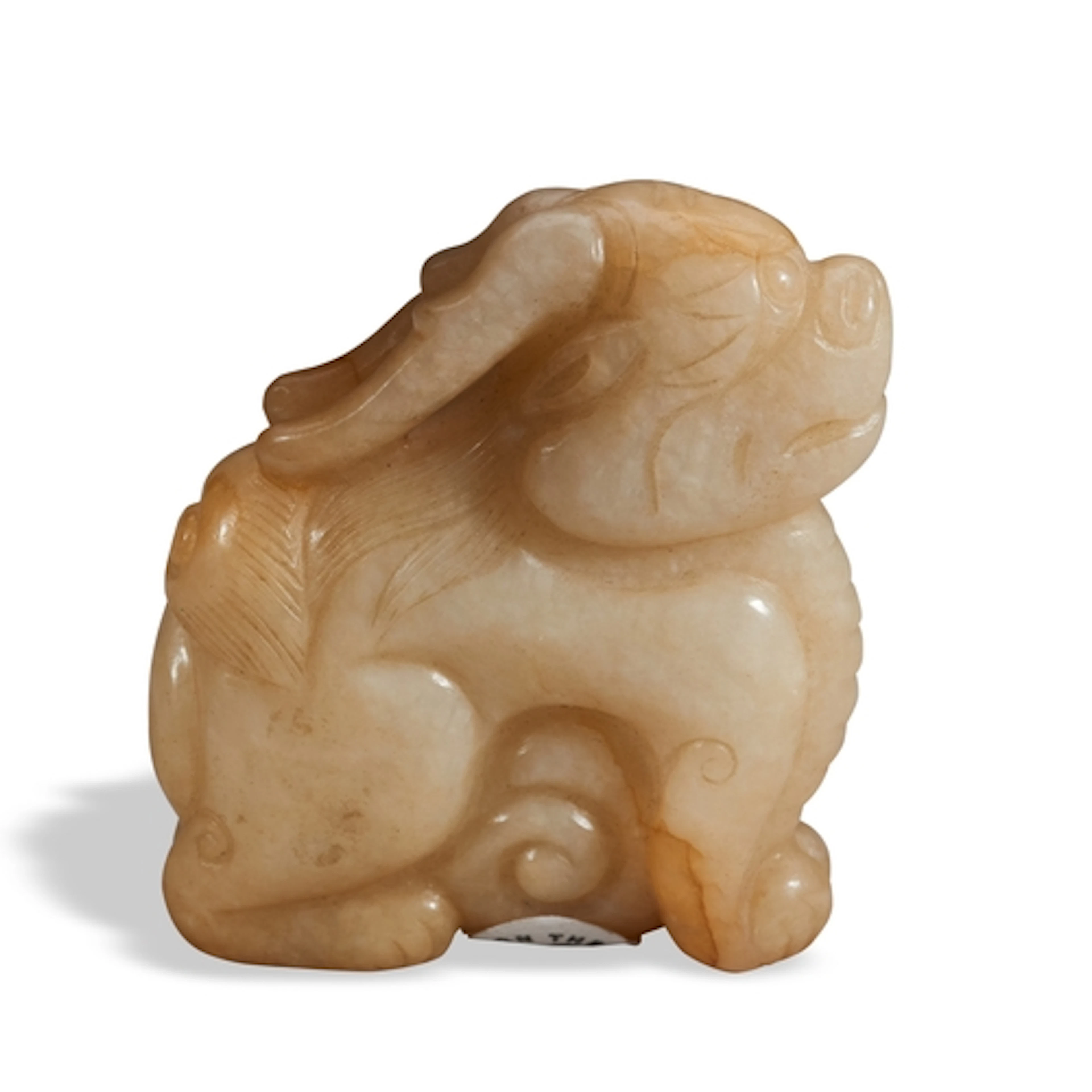 A MOTTLED CARAMEL JADE FIGURE OF BIXIE QING DYNASTY, 19TH CE...